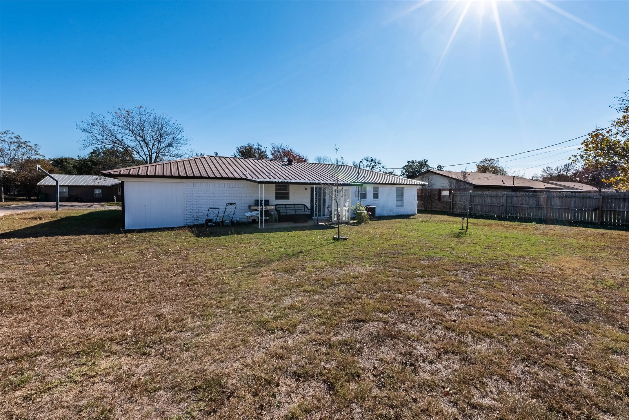 Rear view of property with a yard