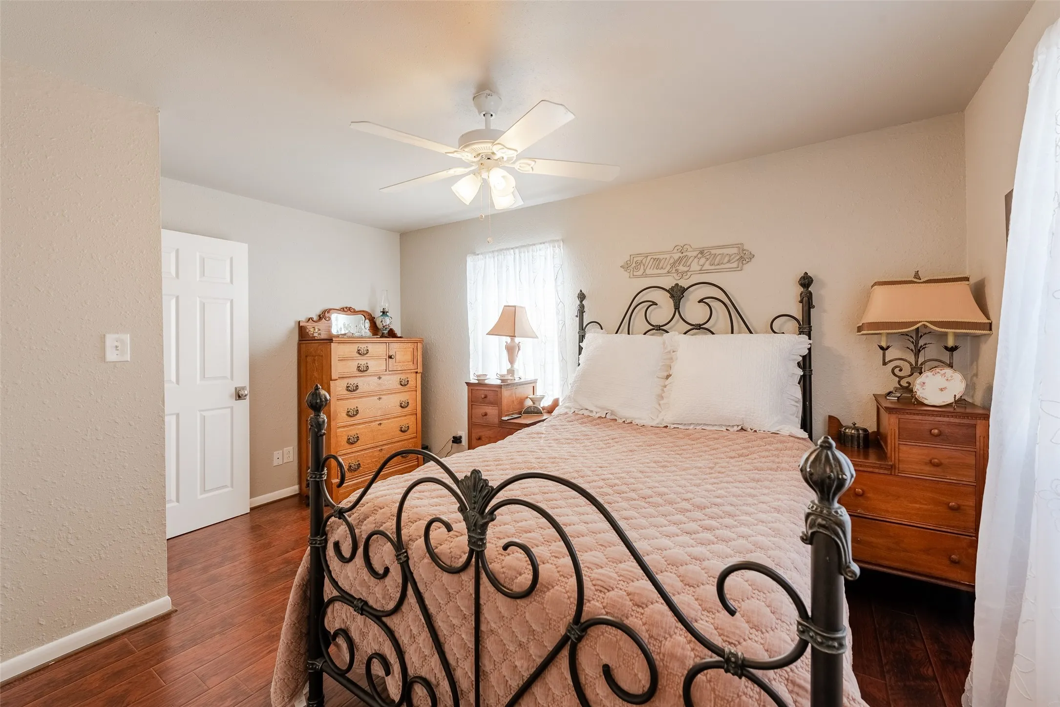 Bedroom with ceiling fan and dark hardwood / wood-style floors
