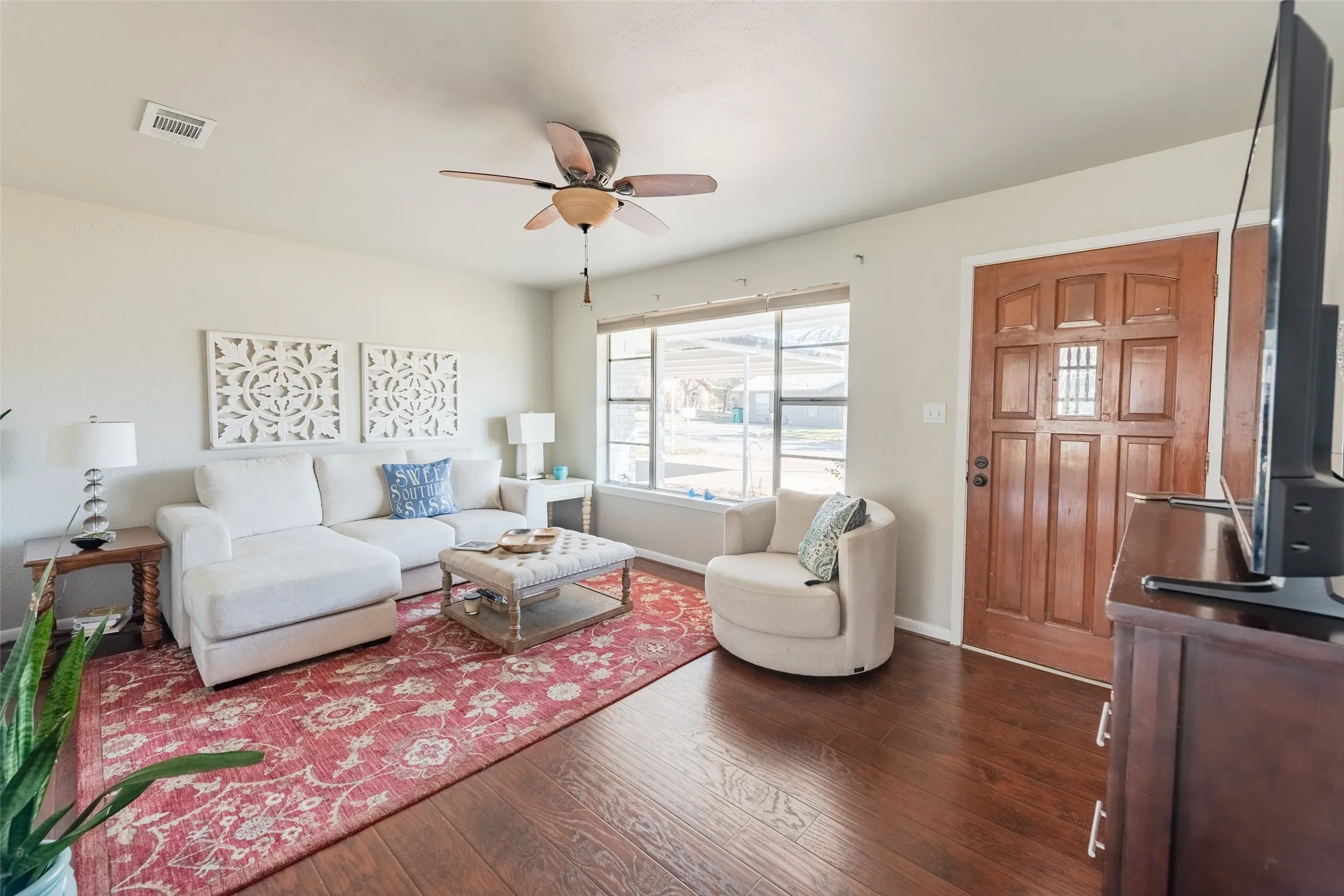 Living room featuring ceiling fan and dark hardwood / wood-style flooring