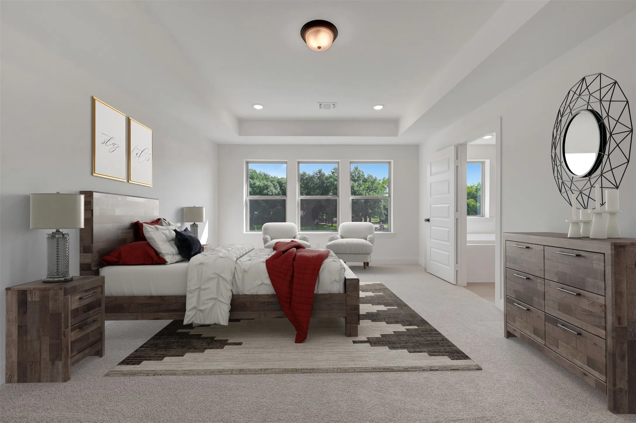 Spacious primary bedroom featuring large multi-pane windows with natural light, wood-finish flooring, and neutral wall finishes