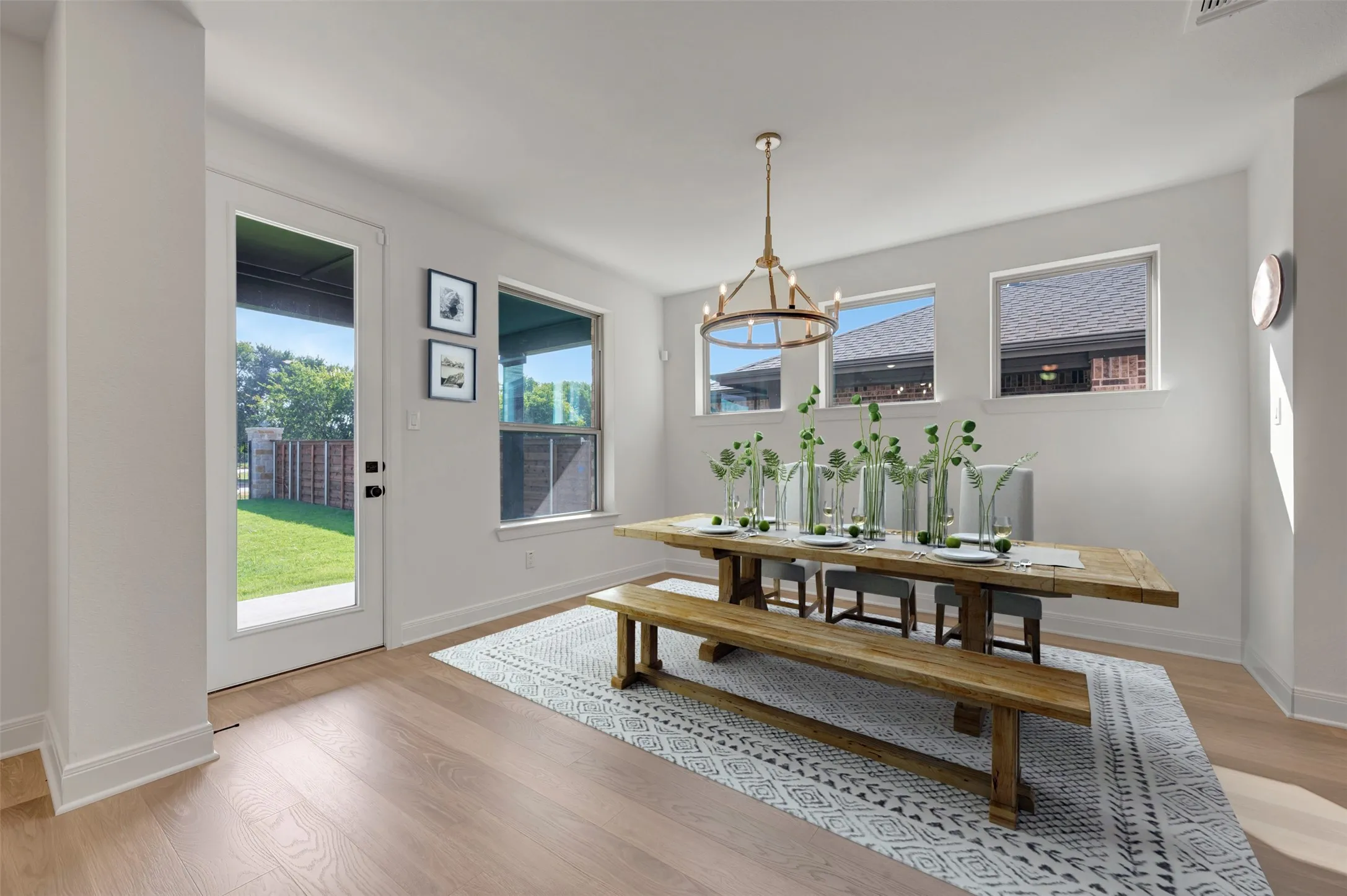 Dining area featuring light wood-finish flooring and a white color palette
