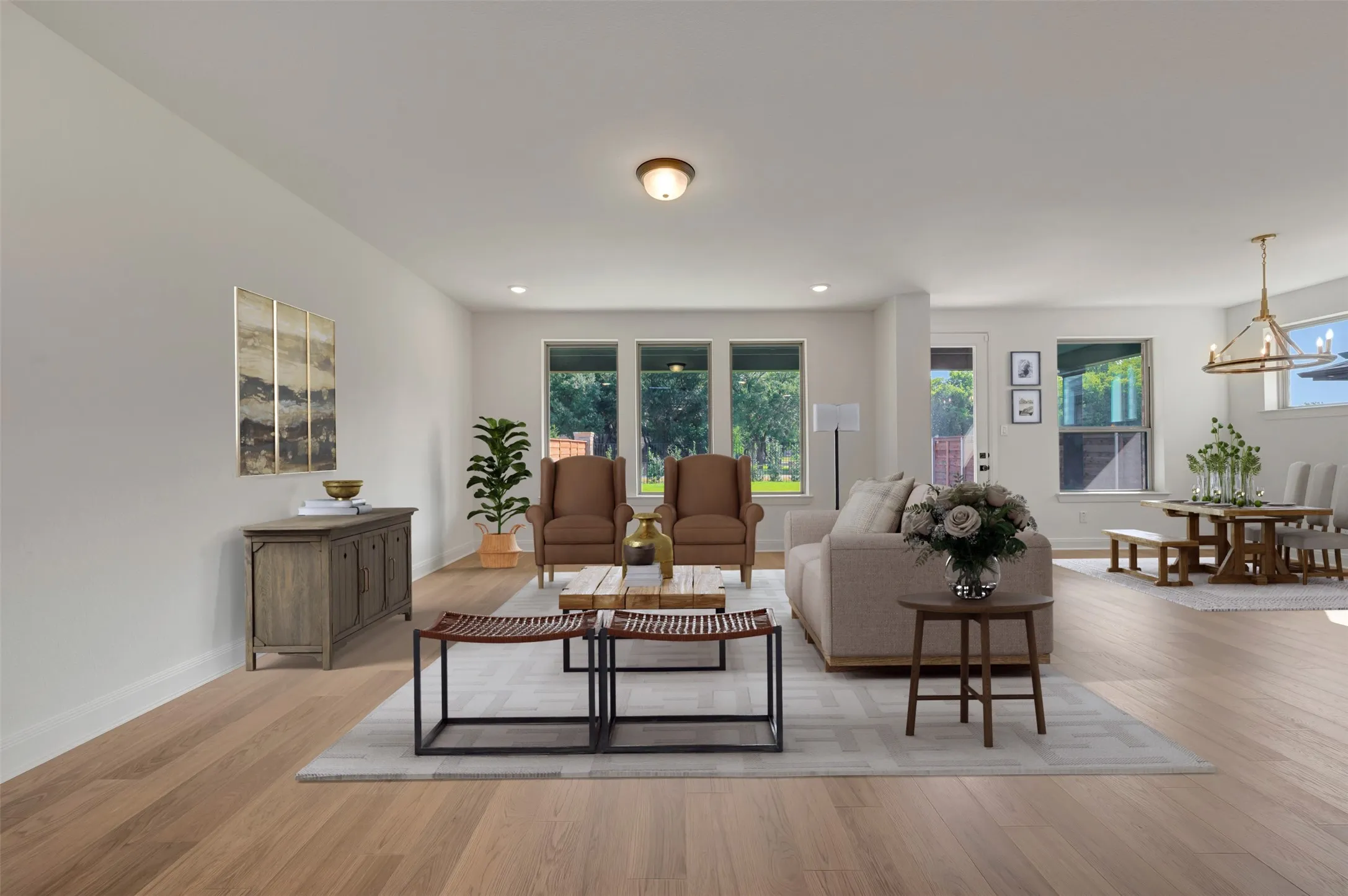 Spacious interior featuring wood-finish flooring throughout, recessed lighting, and multiple large windows providing ample natural light
