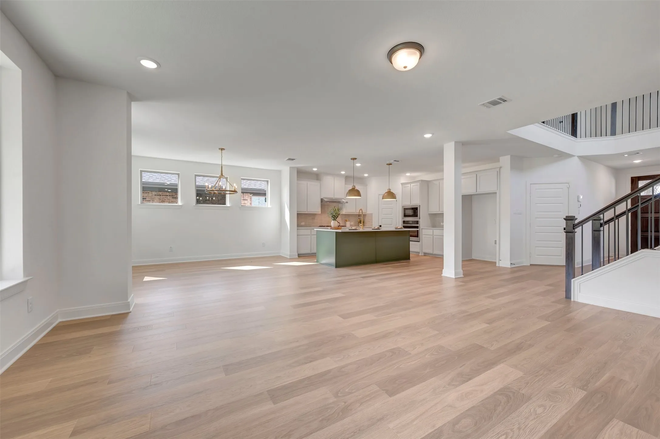 Open-concept living space with light wood-finish flooring