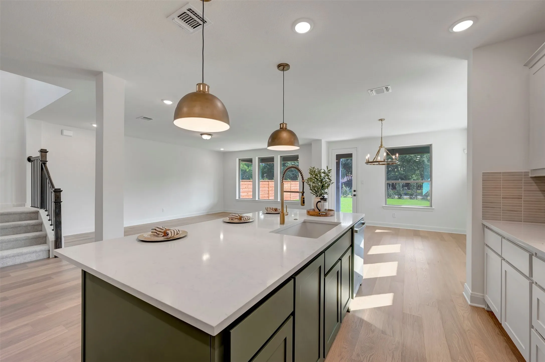 Kitchen island featuring a white countertop and dark green cabinetry