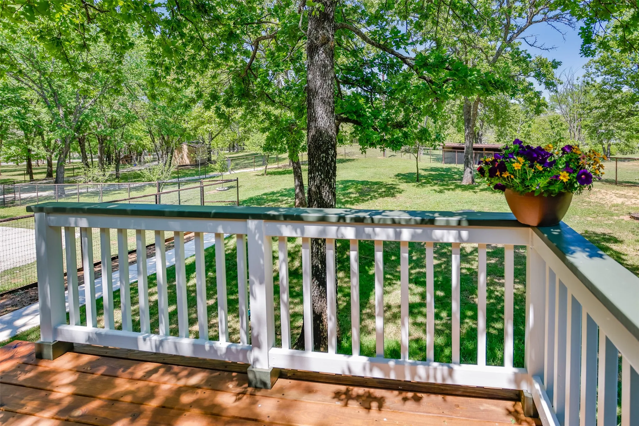 Front deck/patio with stained decking and railings