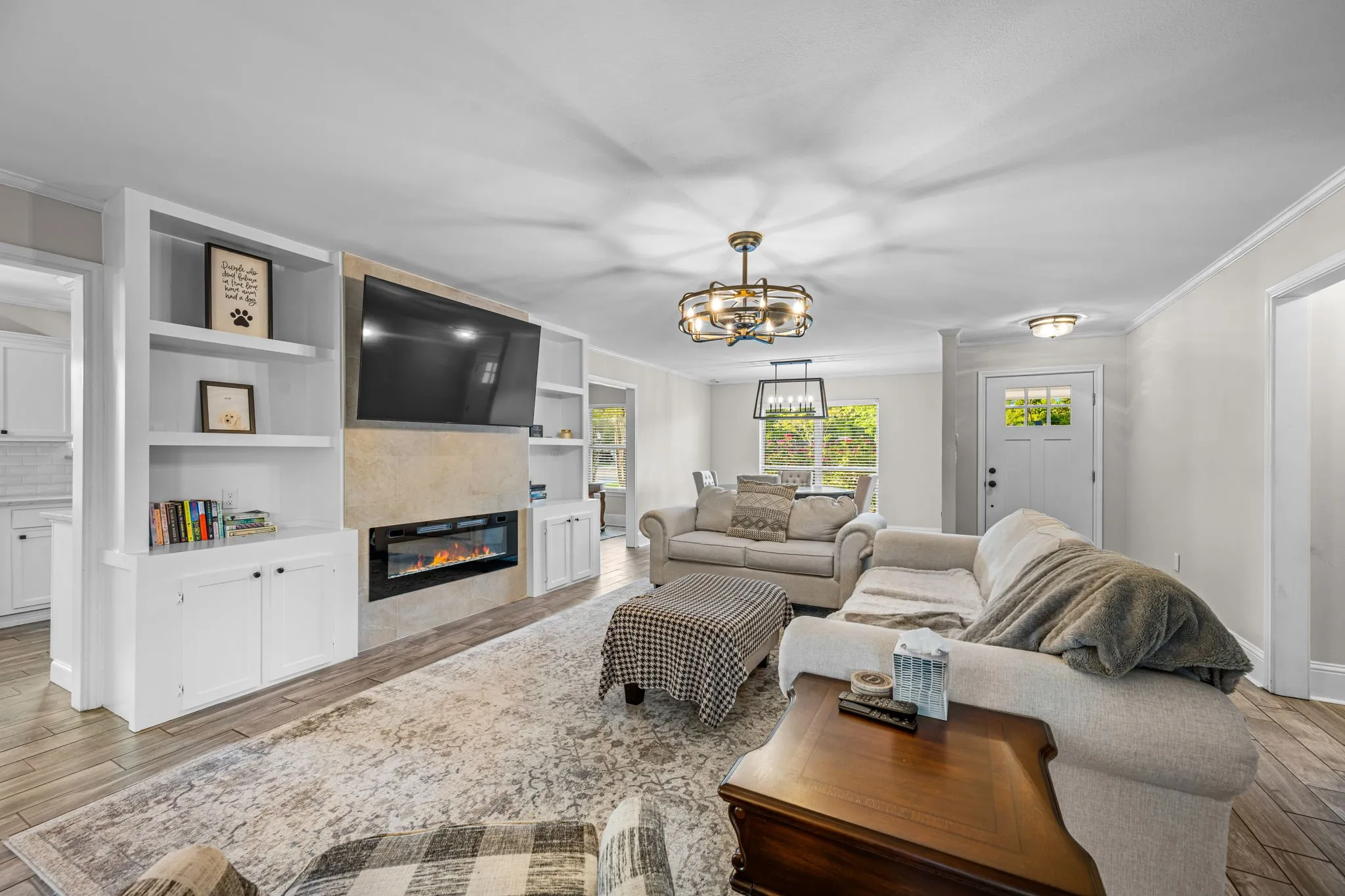 Living room featuring beautiful built ins and an electric fireplace