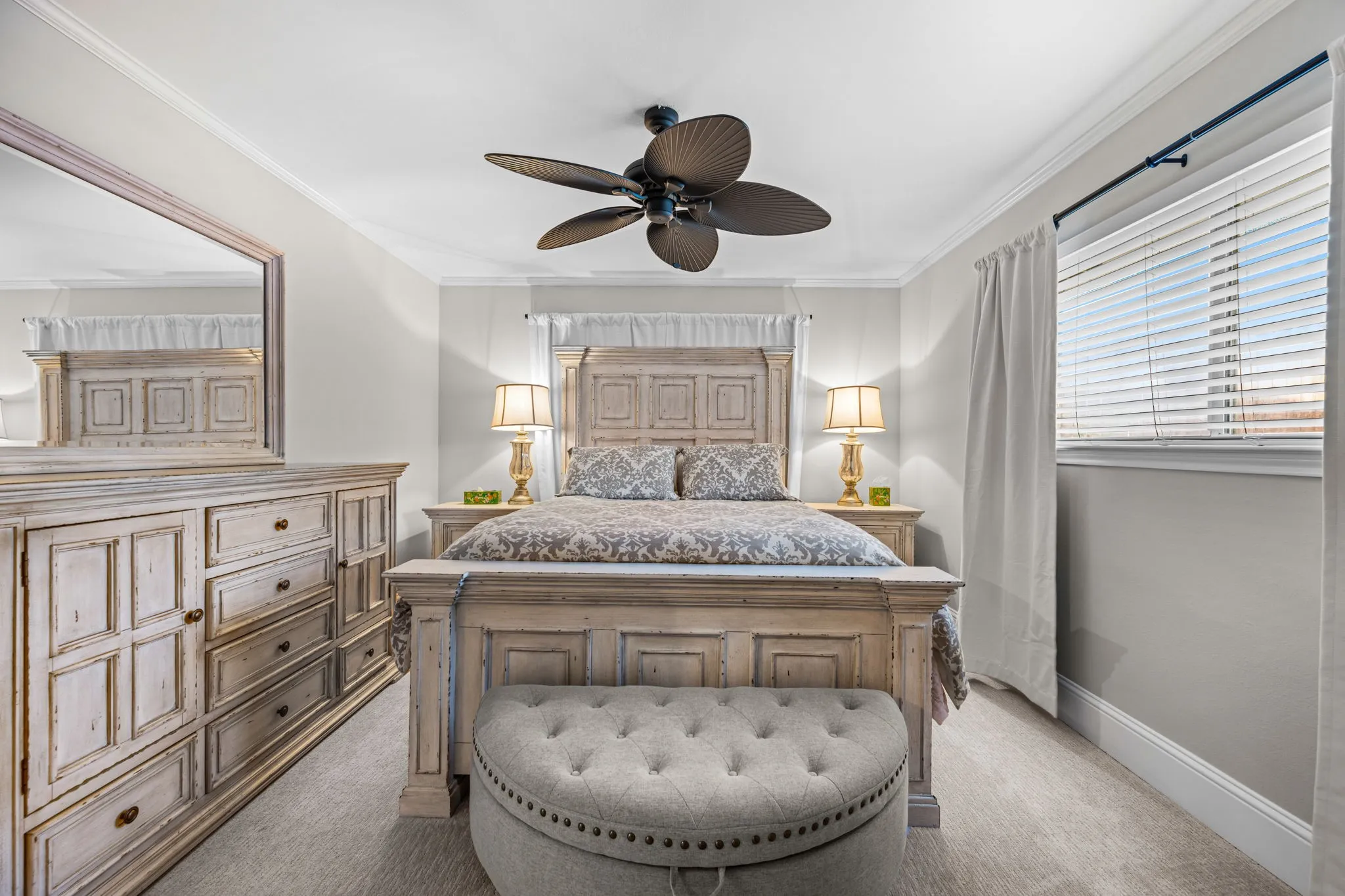The primary bedroom has a ceiling fan and great natural light.