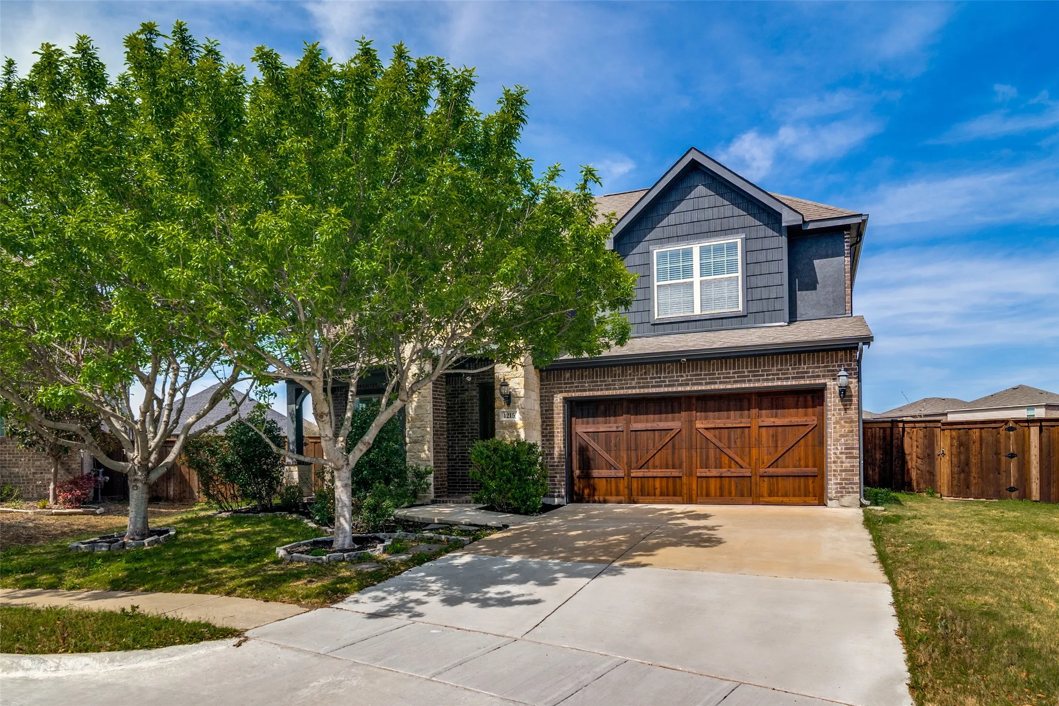 View of front of property well landscaped and sitting on a 1/3acre lot