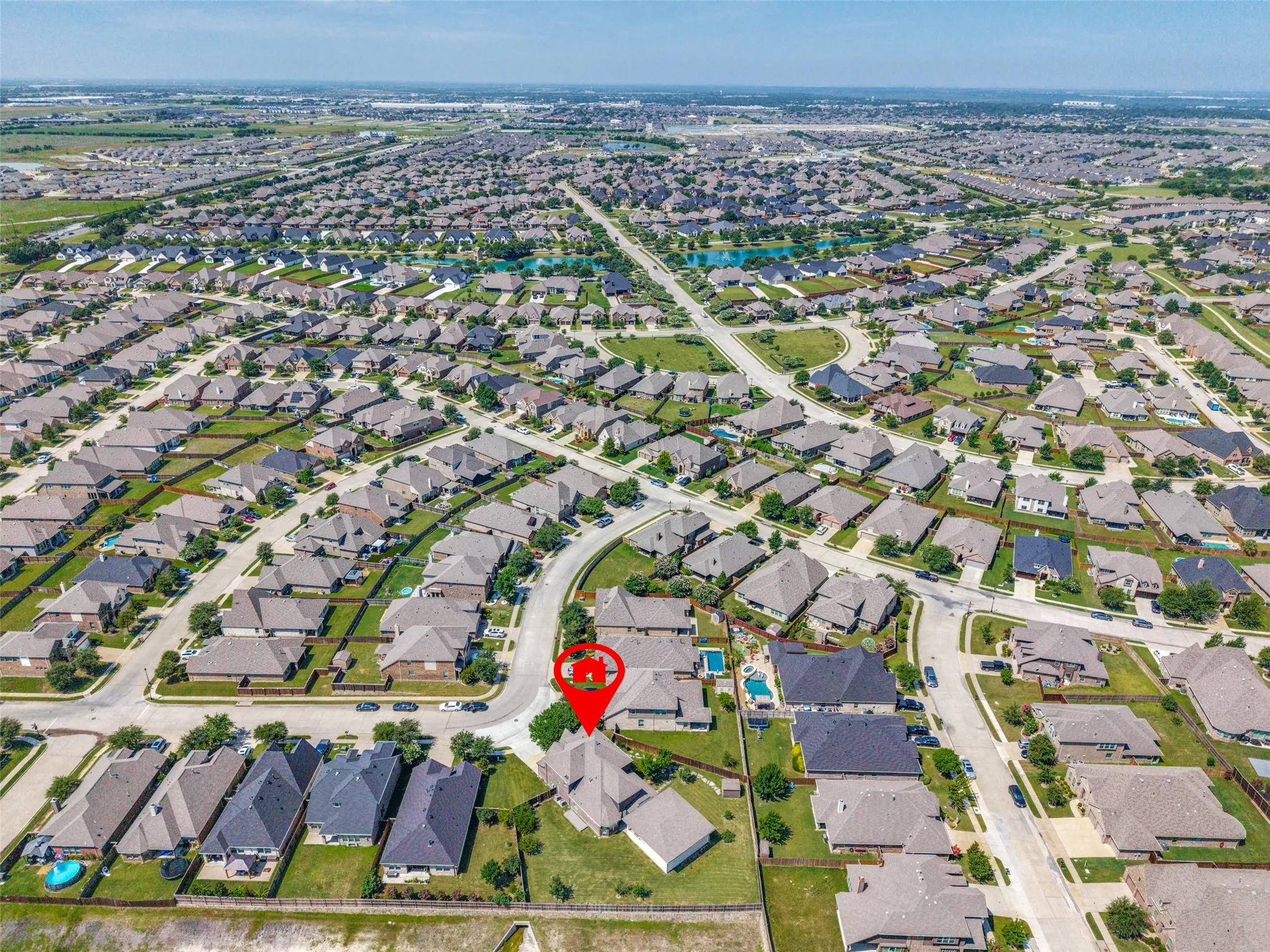 Expansive aerial showcasing a residential neighborhood with numerous single-family homes