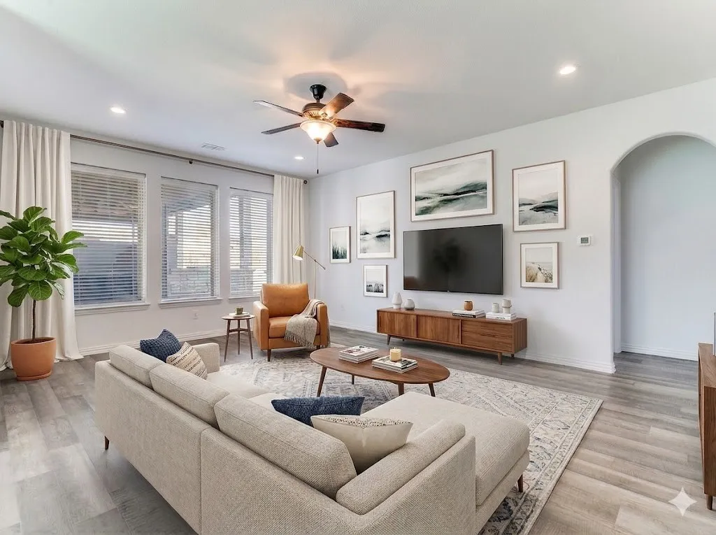 Living room with arched walkways, a ceiling fan, light wood-type flooring, and recessed lighting