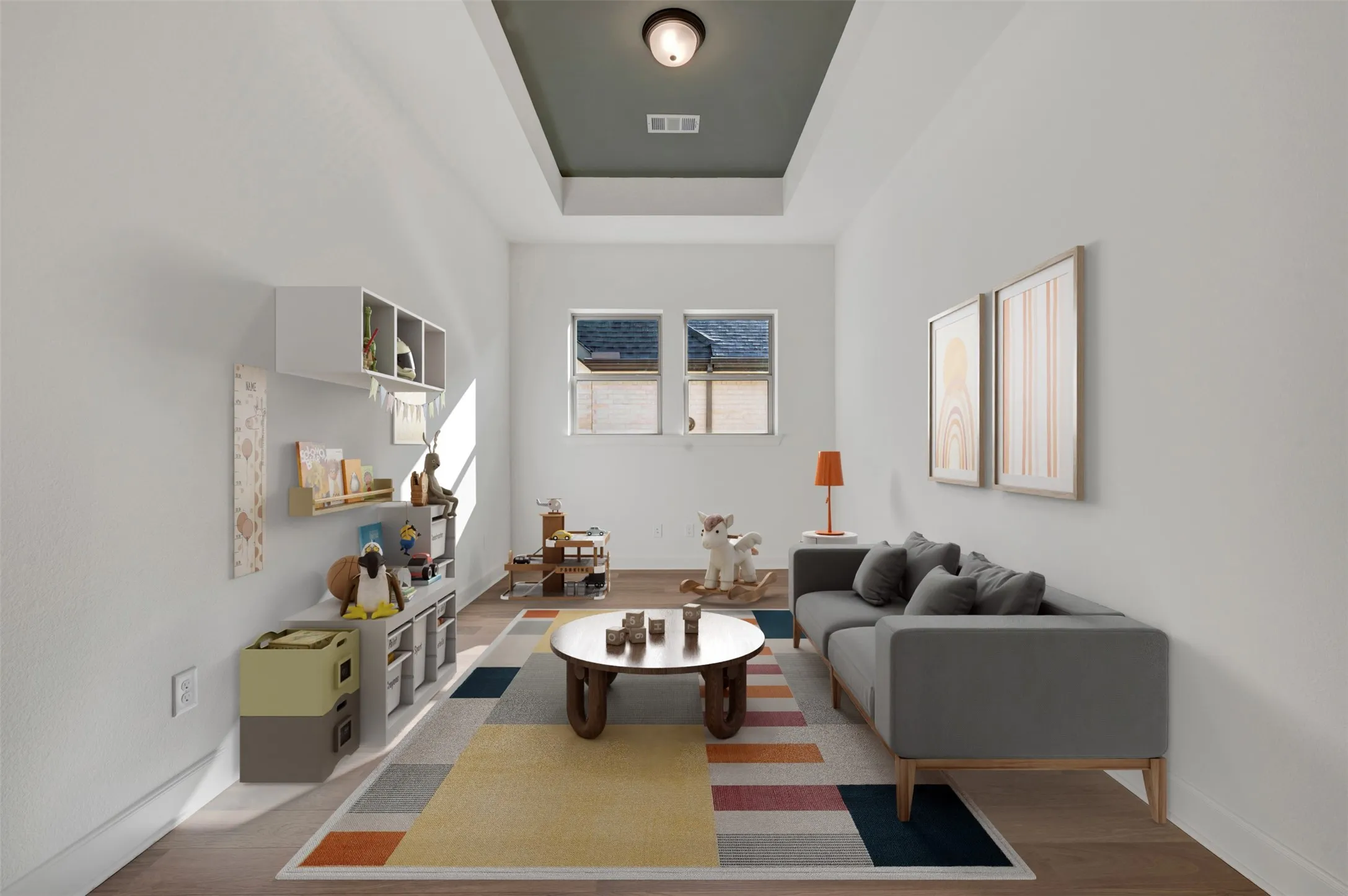 Recessed tray ceiling with a dark accent color, wood-finish flooring, two windows, and white baseboards