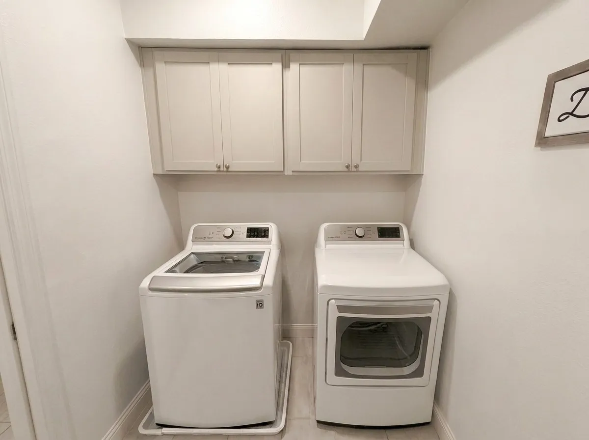 Utility laundry room with cabinets