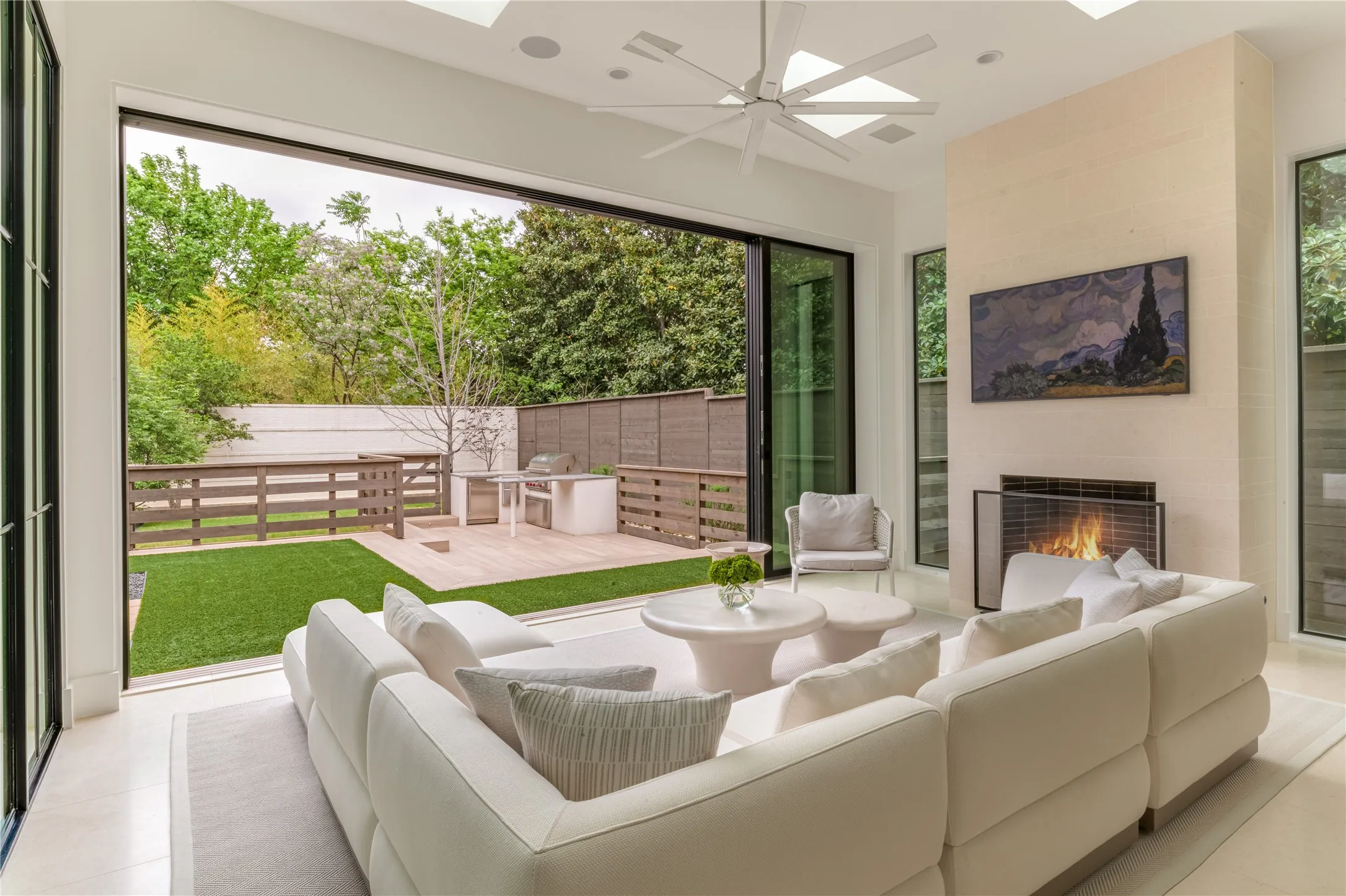 Sunroom with Isokern gas fireplace and sliding doors to backyard