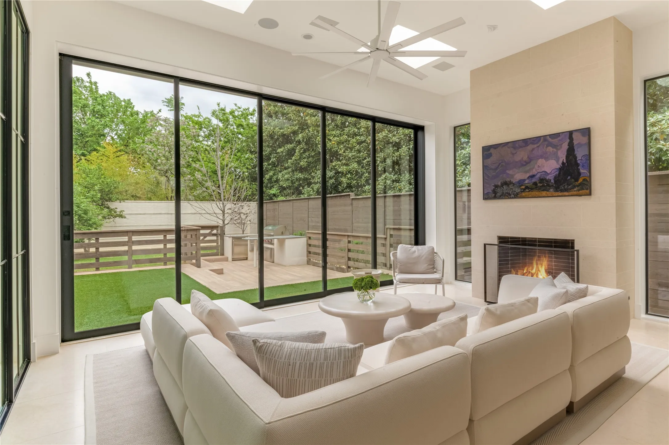 Sunroom with Isokern gas fireplace and sliding doors to backyard
