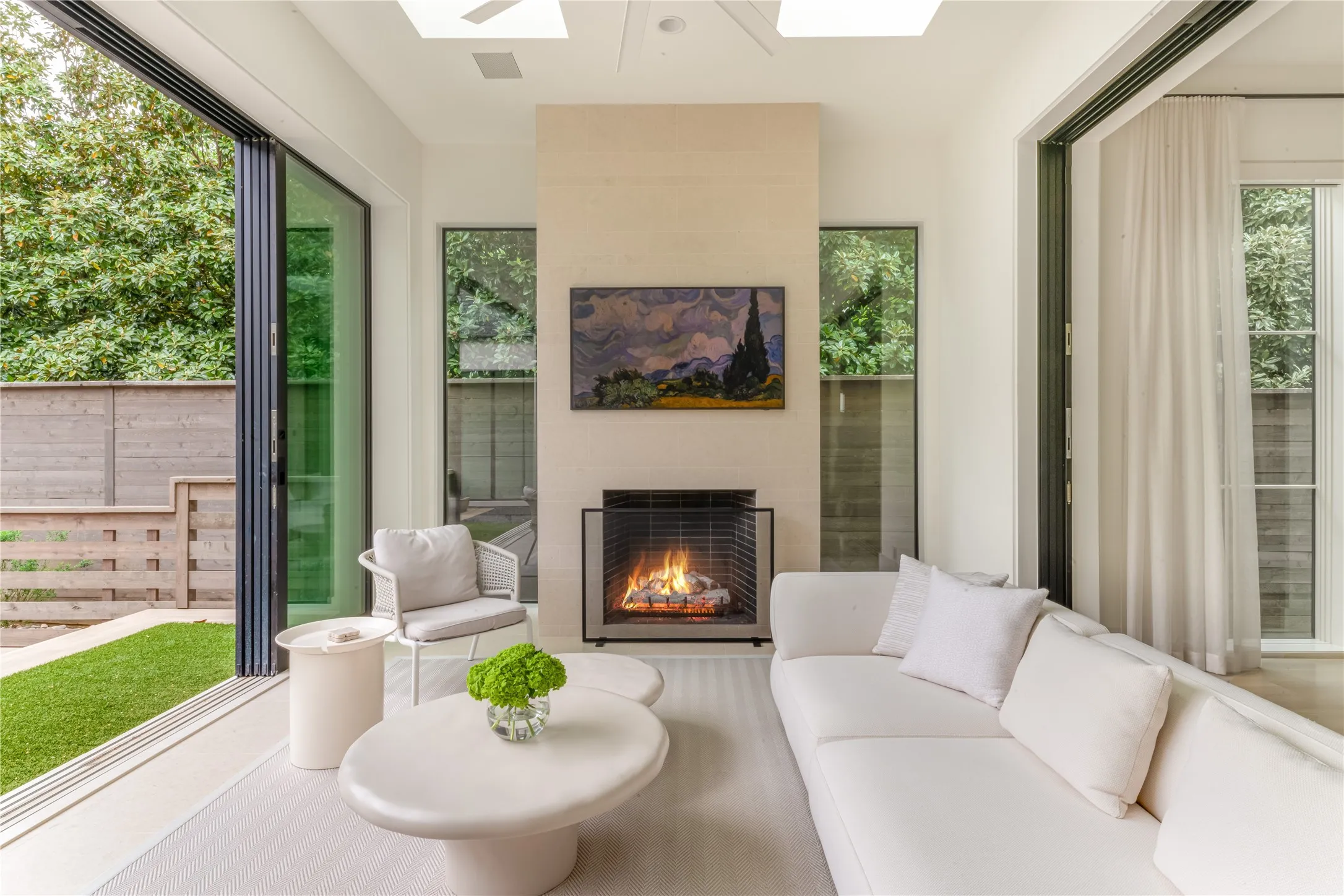 Sunroom with Isokern gas fireplace and sliding doors to backyard