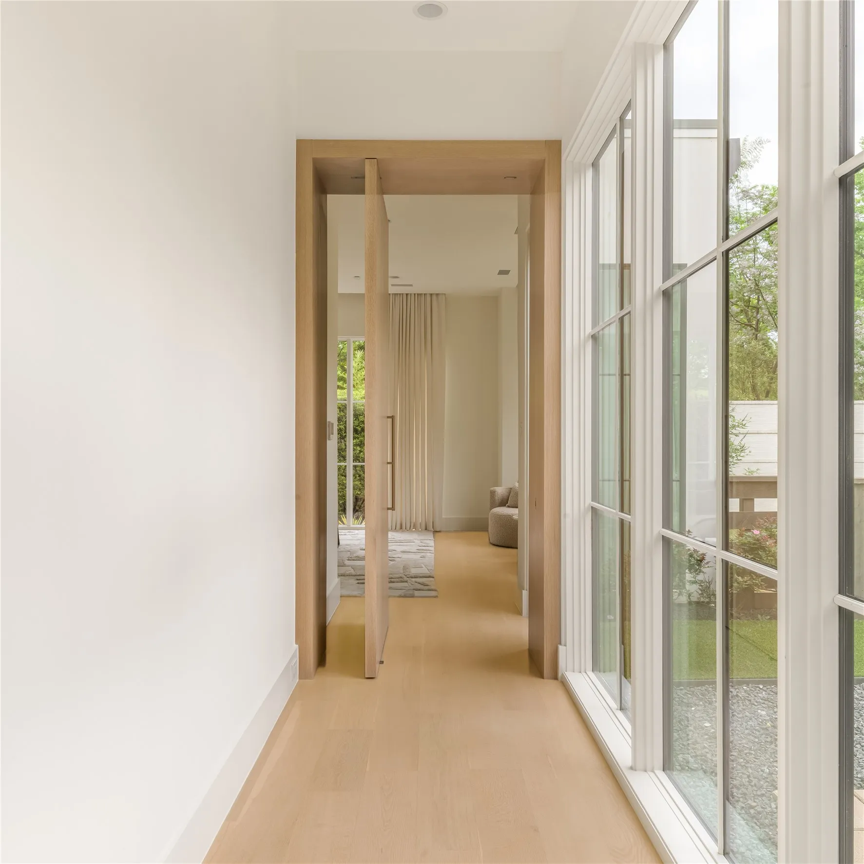 Primary Suite entry with white oak pivot door