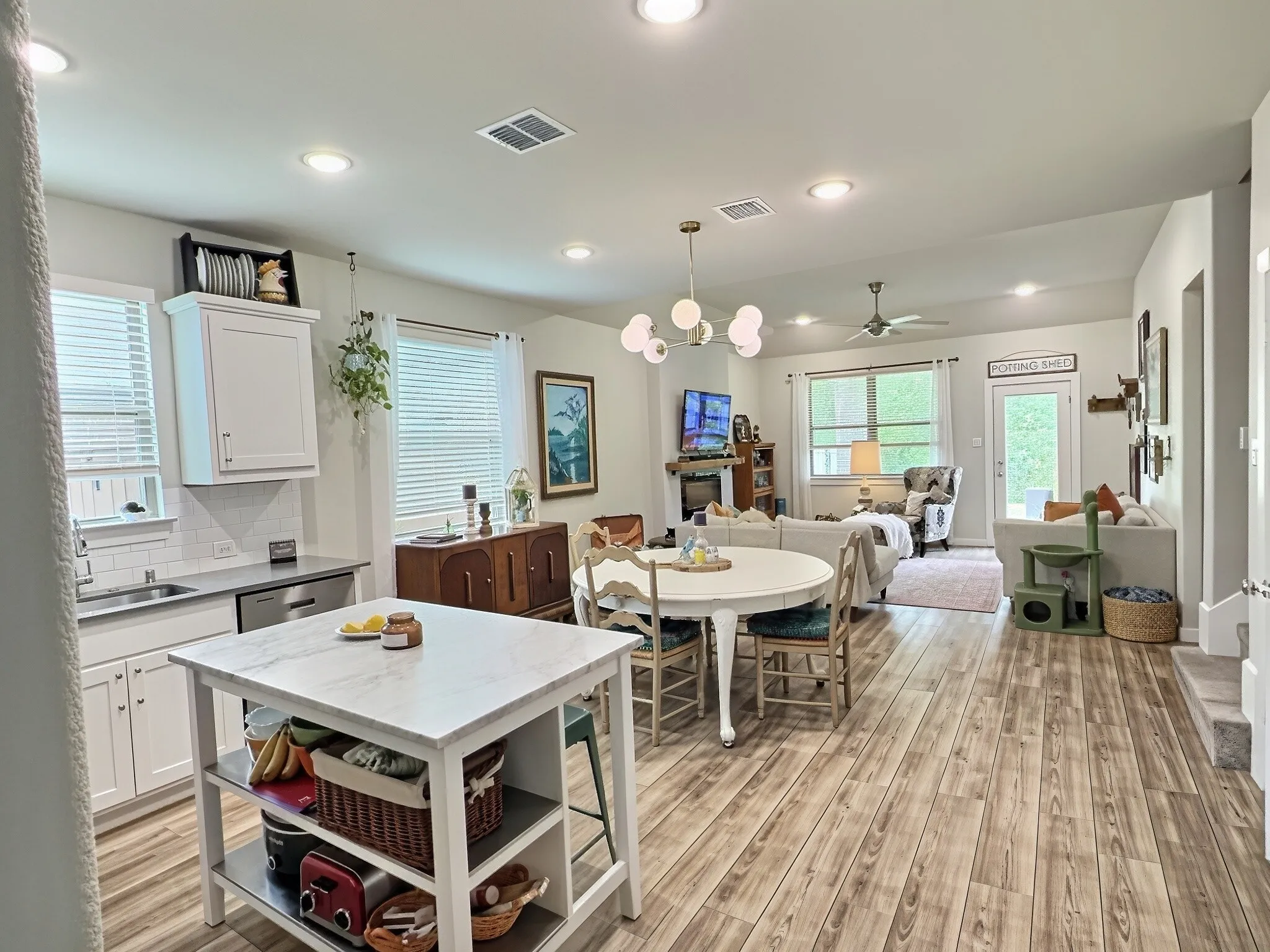 Open floorplan with marble island and eat in kitchen