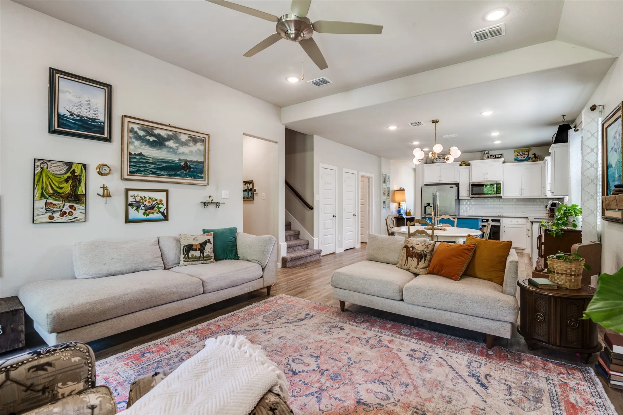 Living room with electric fireplace and open to kitchen