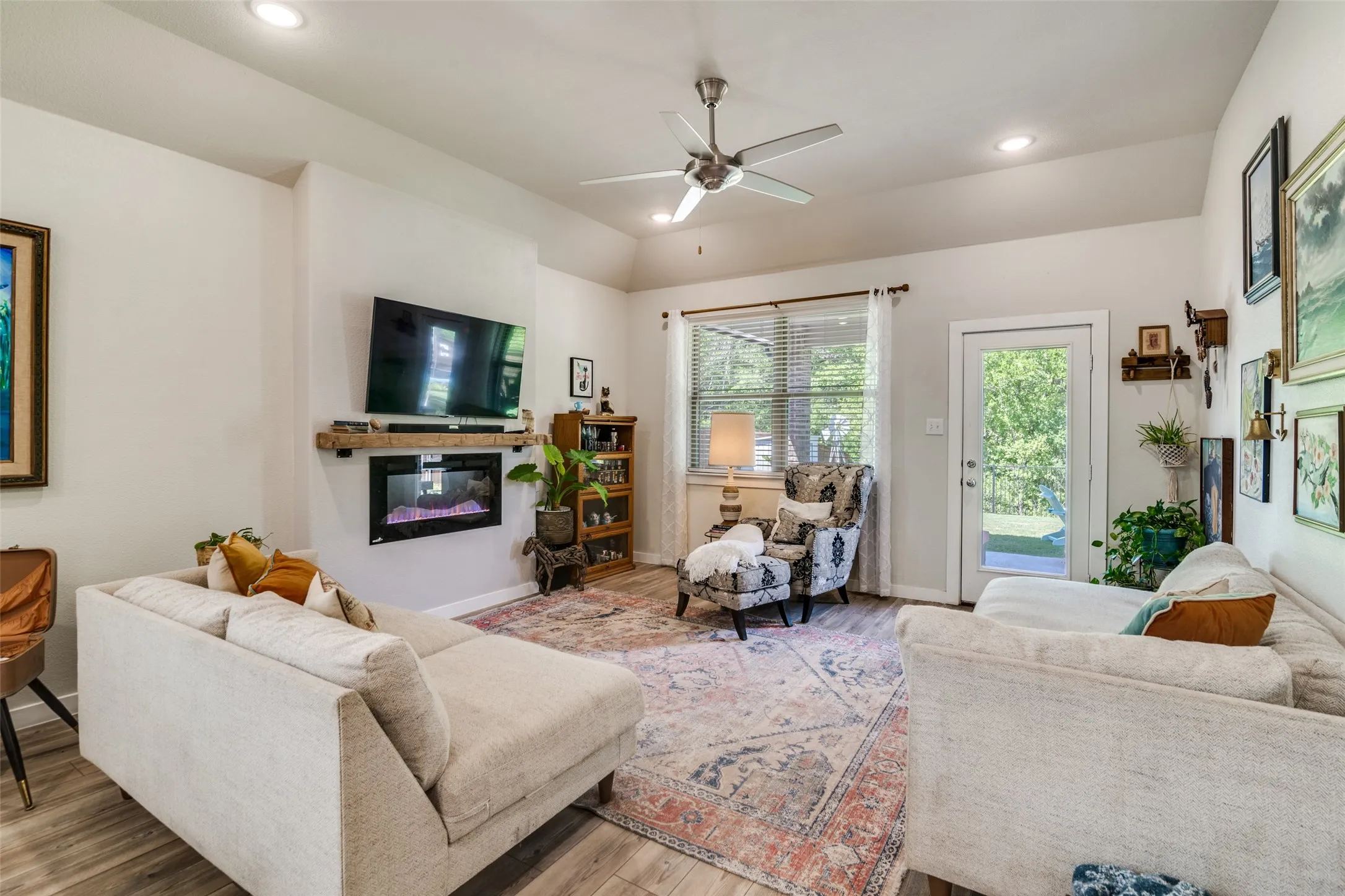 Living room with electric fireplace and open to kitchen