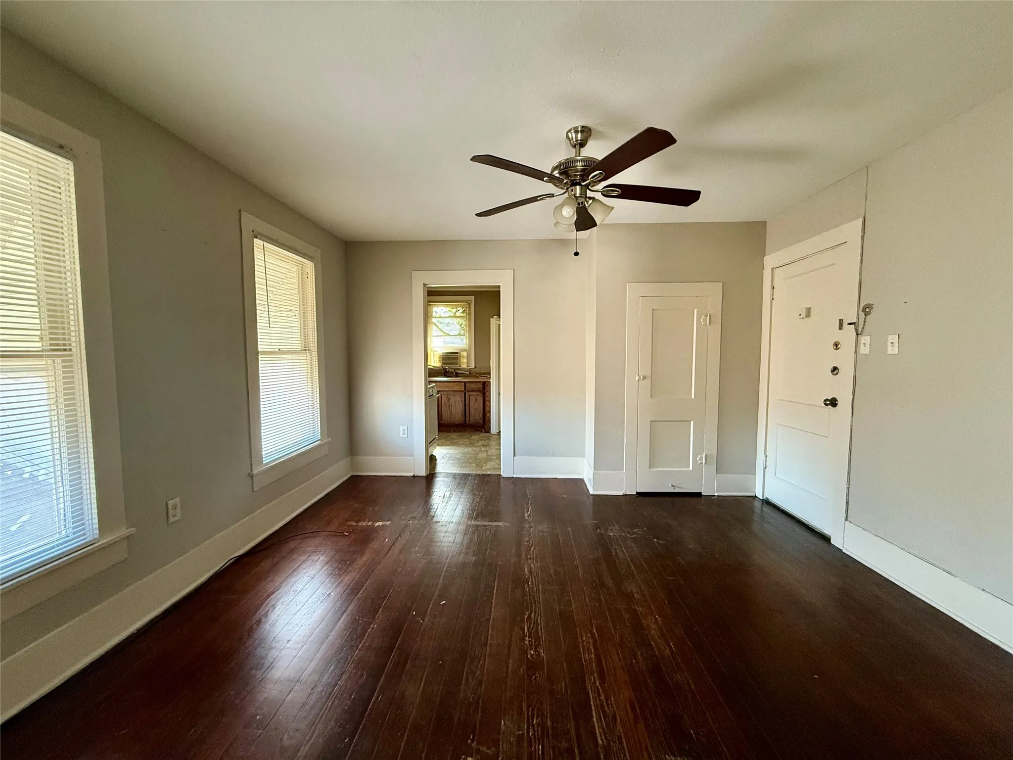 Unfurnished room featuring ceiling fan and dark hardwood / wood-style flooring