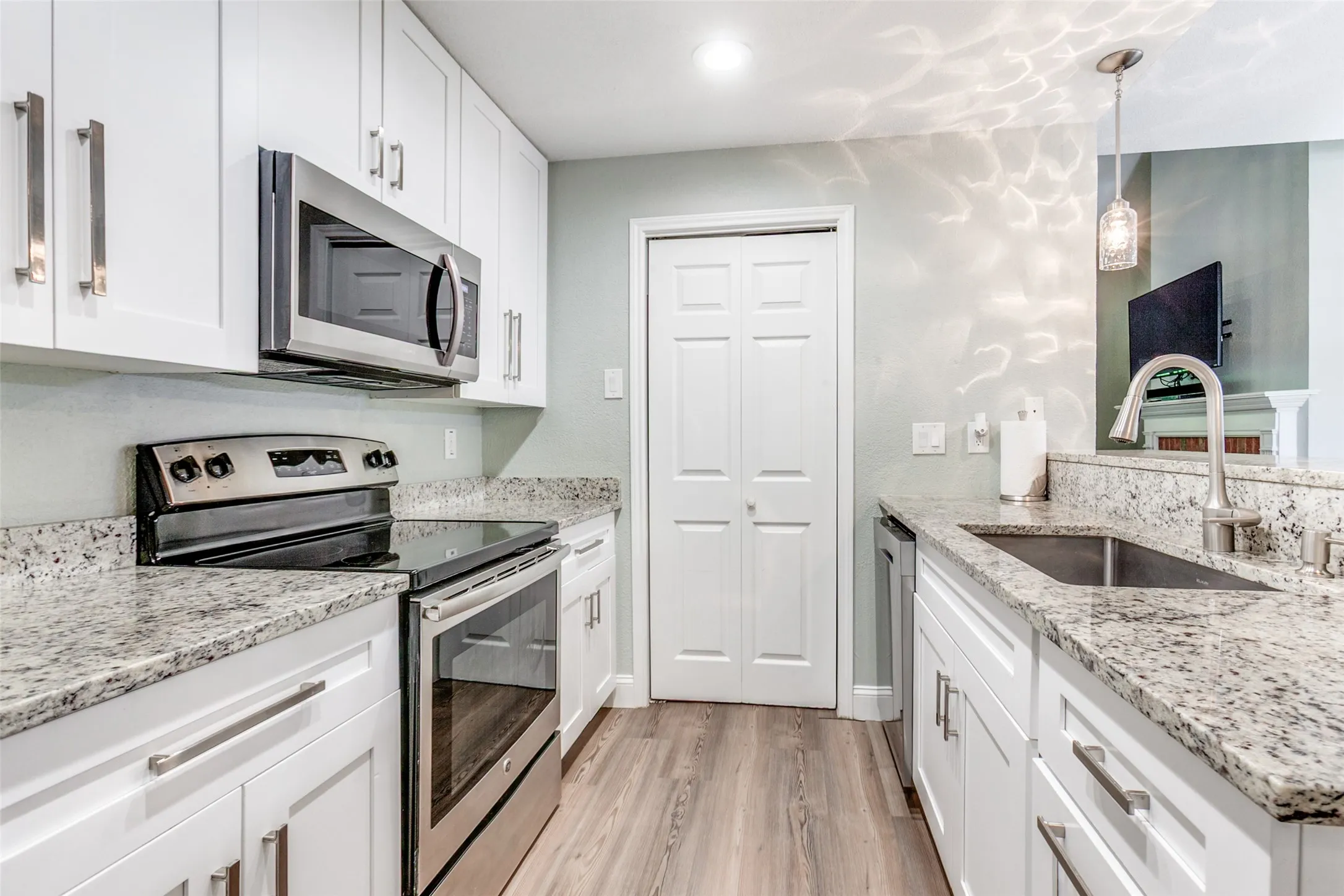Convenient galley kitchen. Door opens to utility room with washer & dryer (can remain)