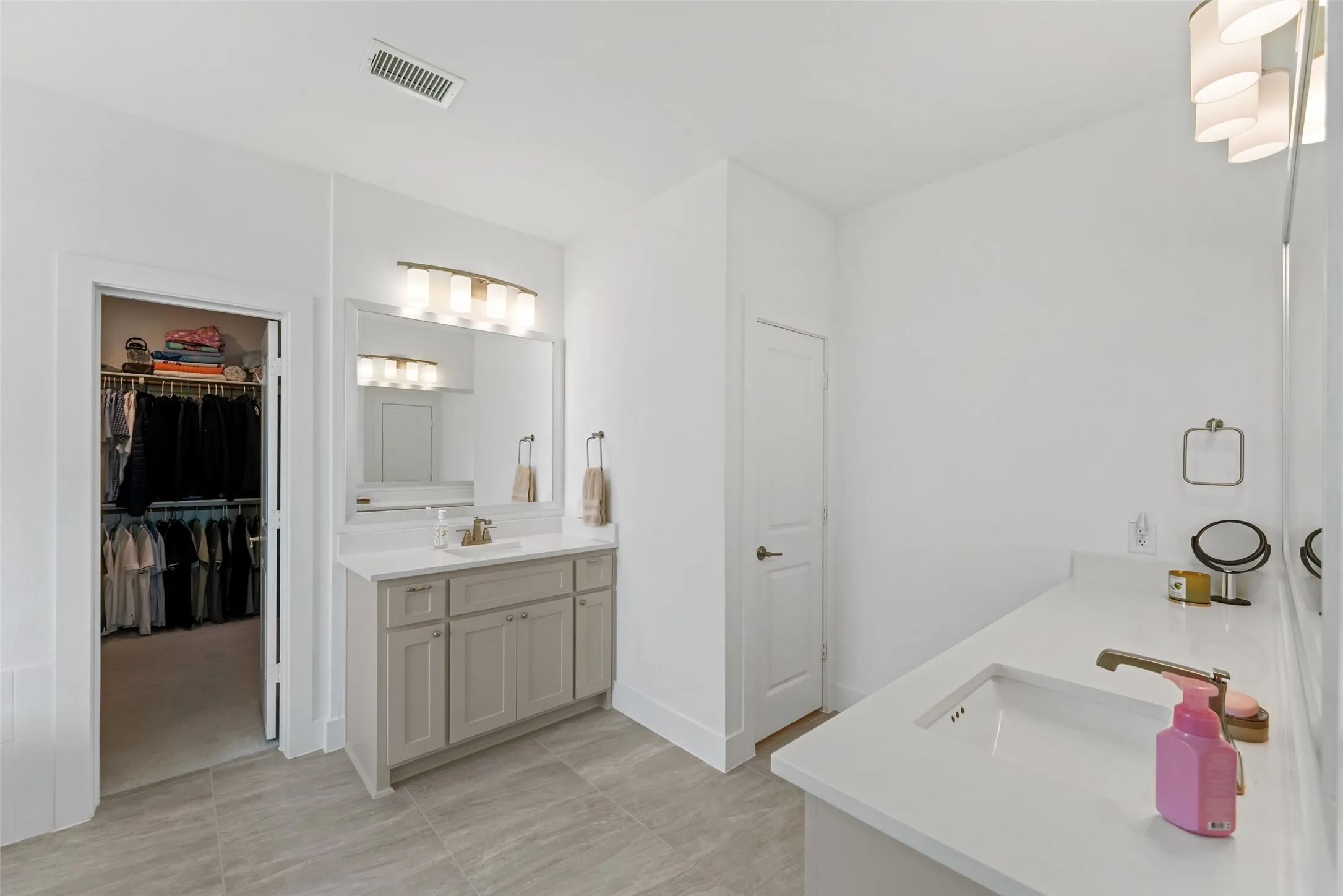 Ensuite Primary Bath features double sinks, walk in closet and toilet room