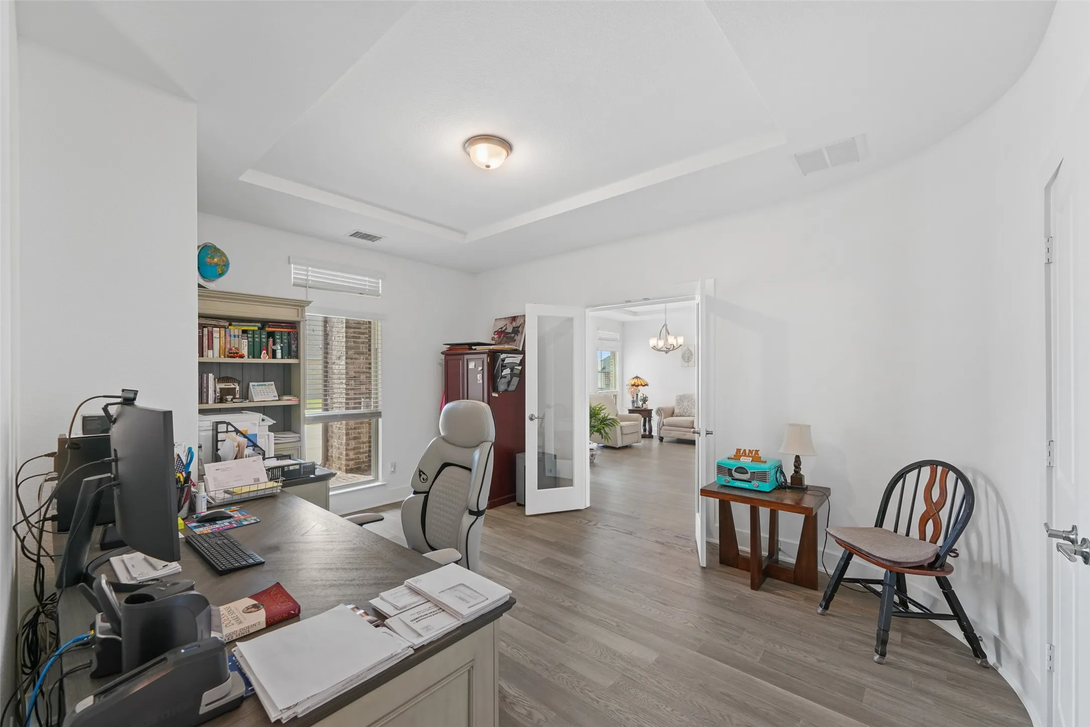 Downstairs office features double glass doors