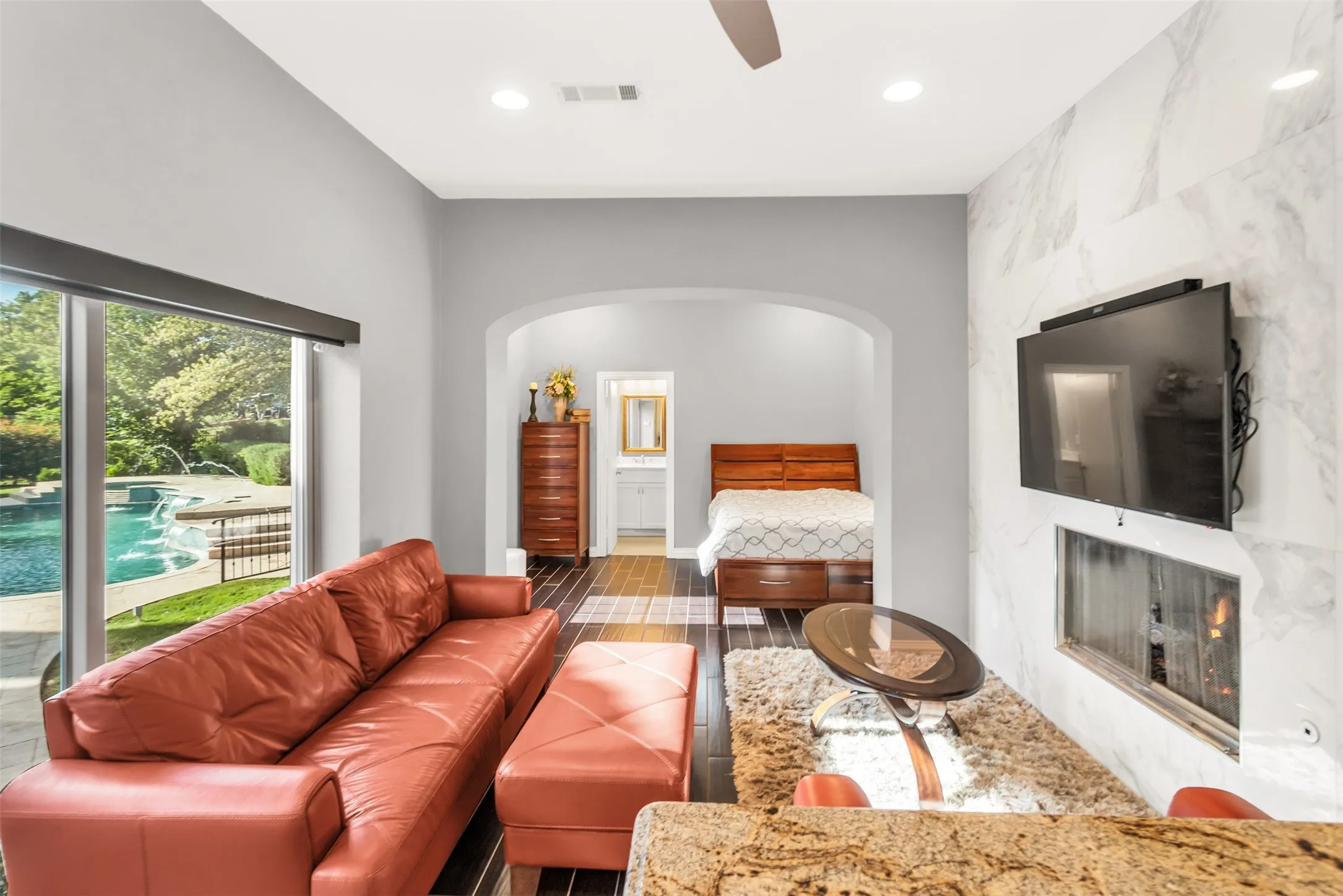 Guest house living area with fireplace, and a view of the bedroom.