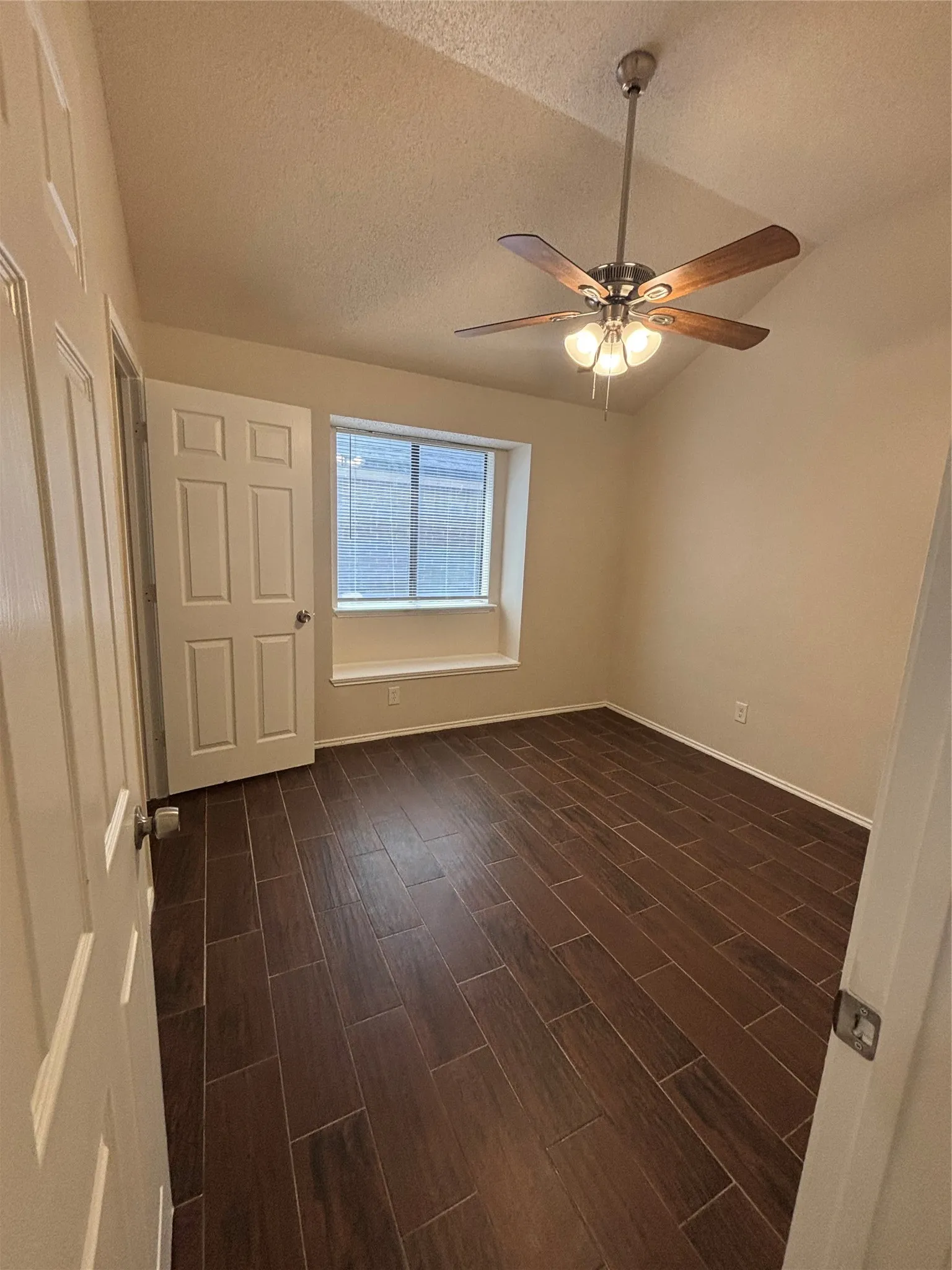 Unfurnished bedroom featuring wood finish floors and a ceiling fan