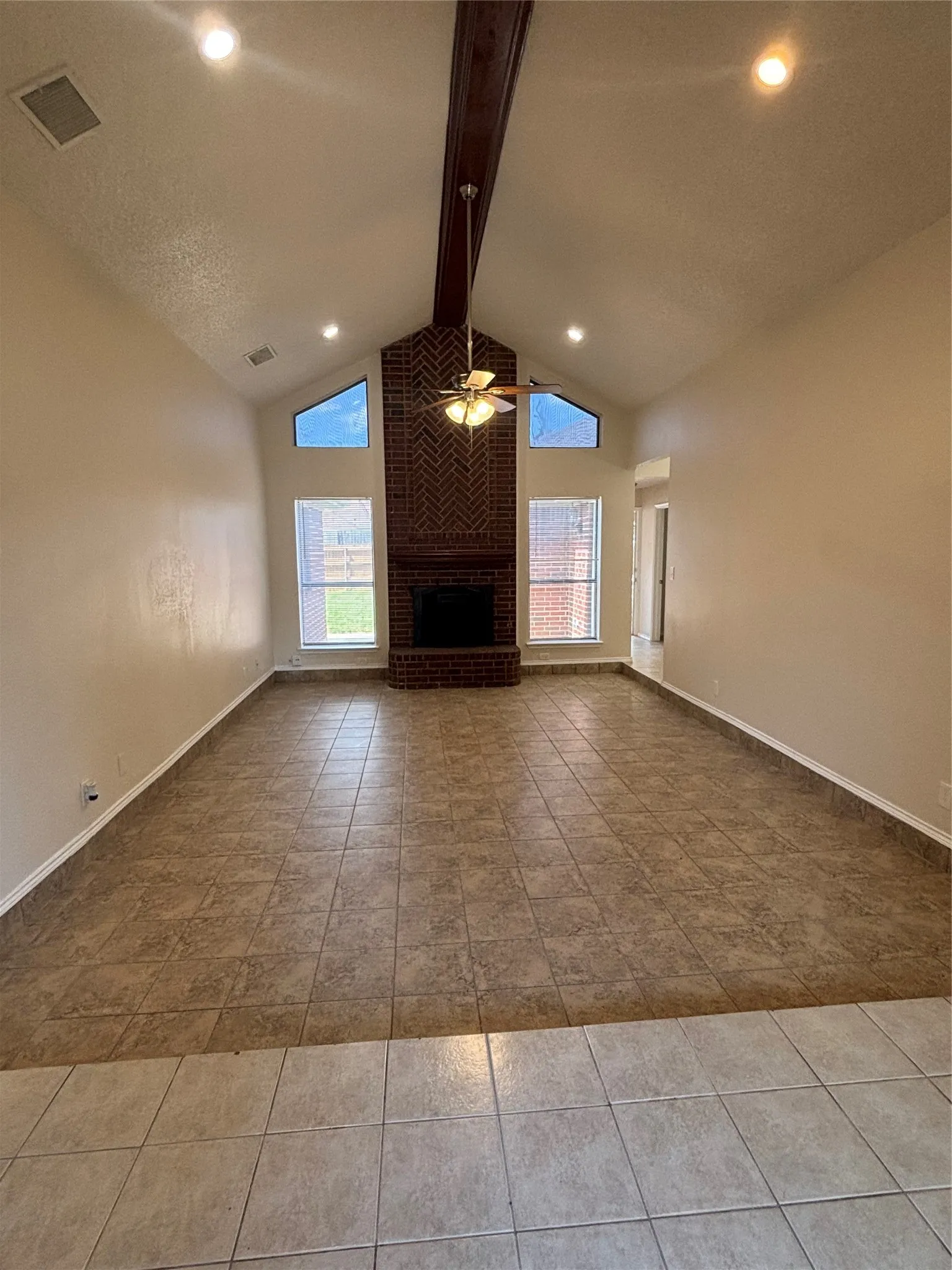 Unfurnished living room featuring a ceiling fan, a fireplace, recessed lighting, and light tile patterned floors