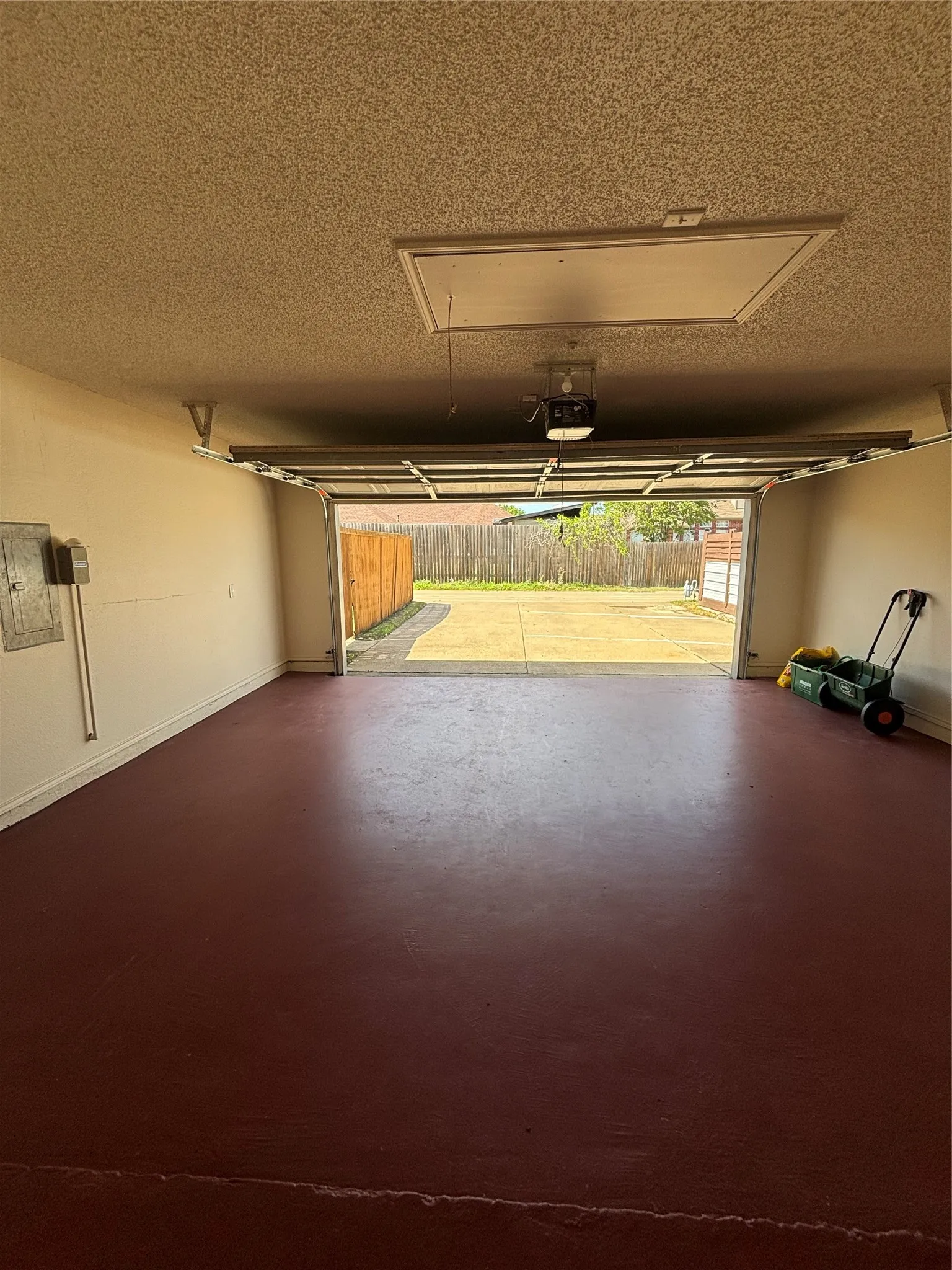 Garage with baseboards and a garage door opener