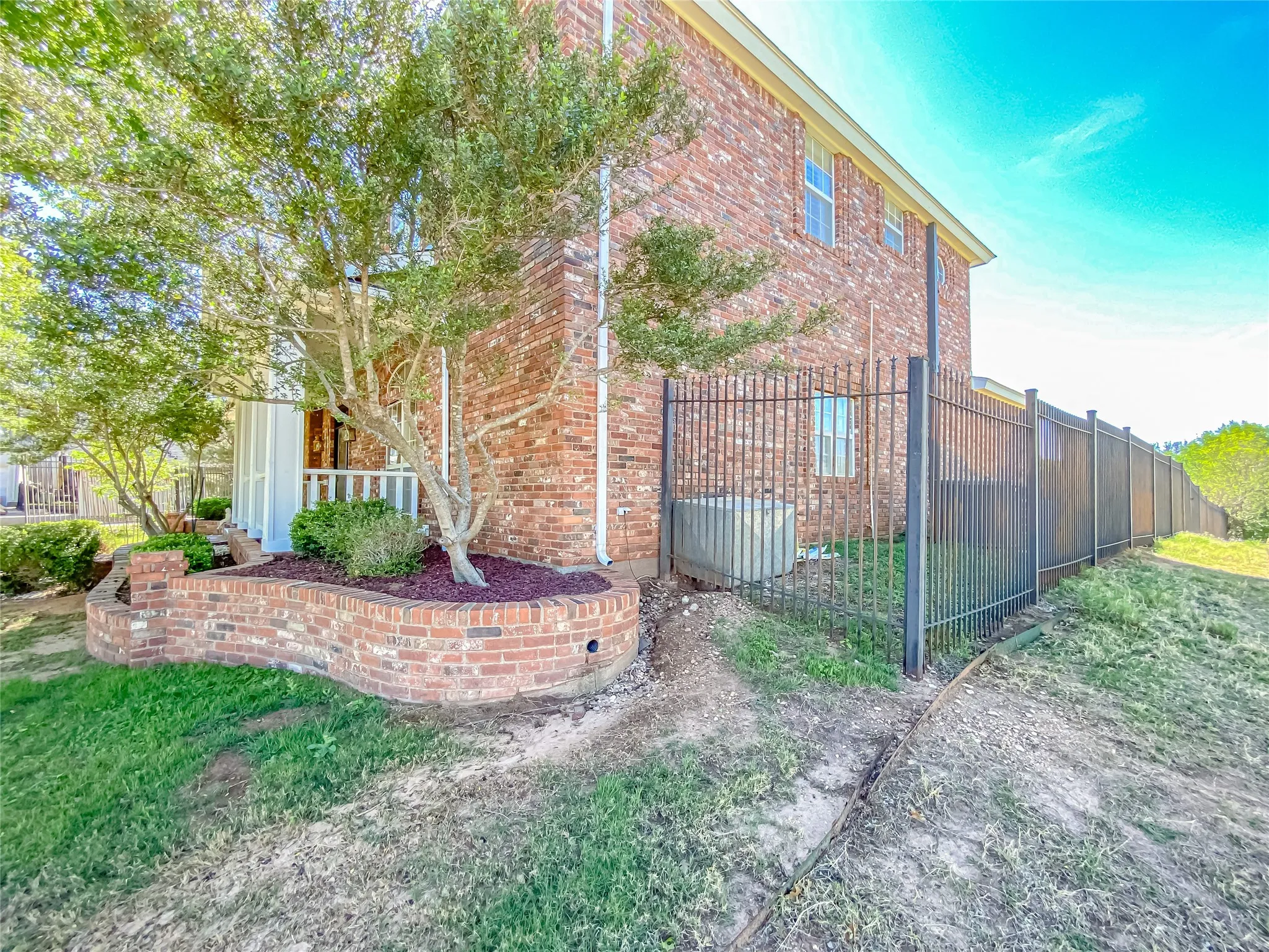View of side of property featuring brick siding