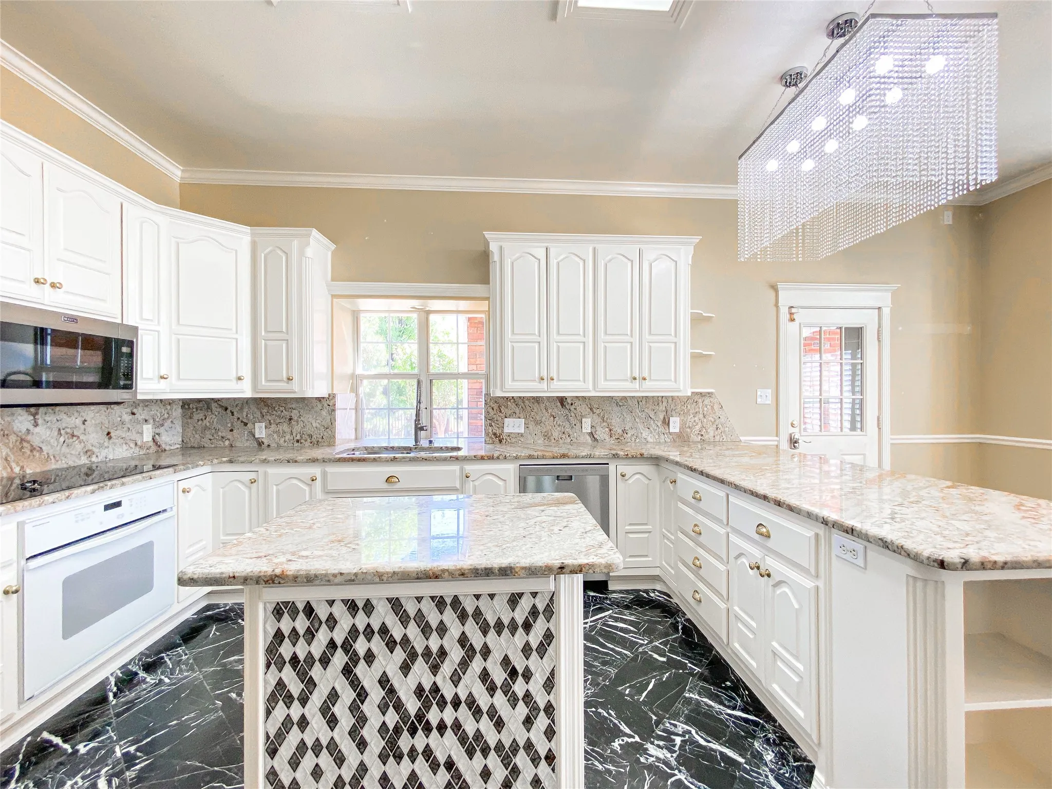 Kitchen featuring open shelves, a peninsula, light stone countertops, stainless steel appliances, and a kitchen island