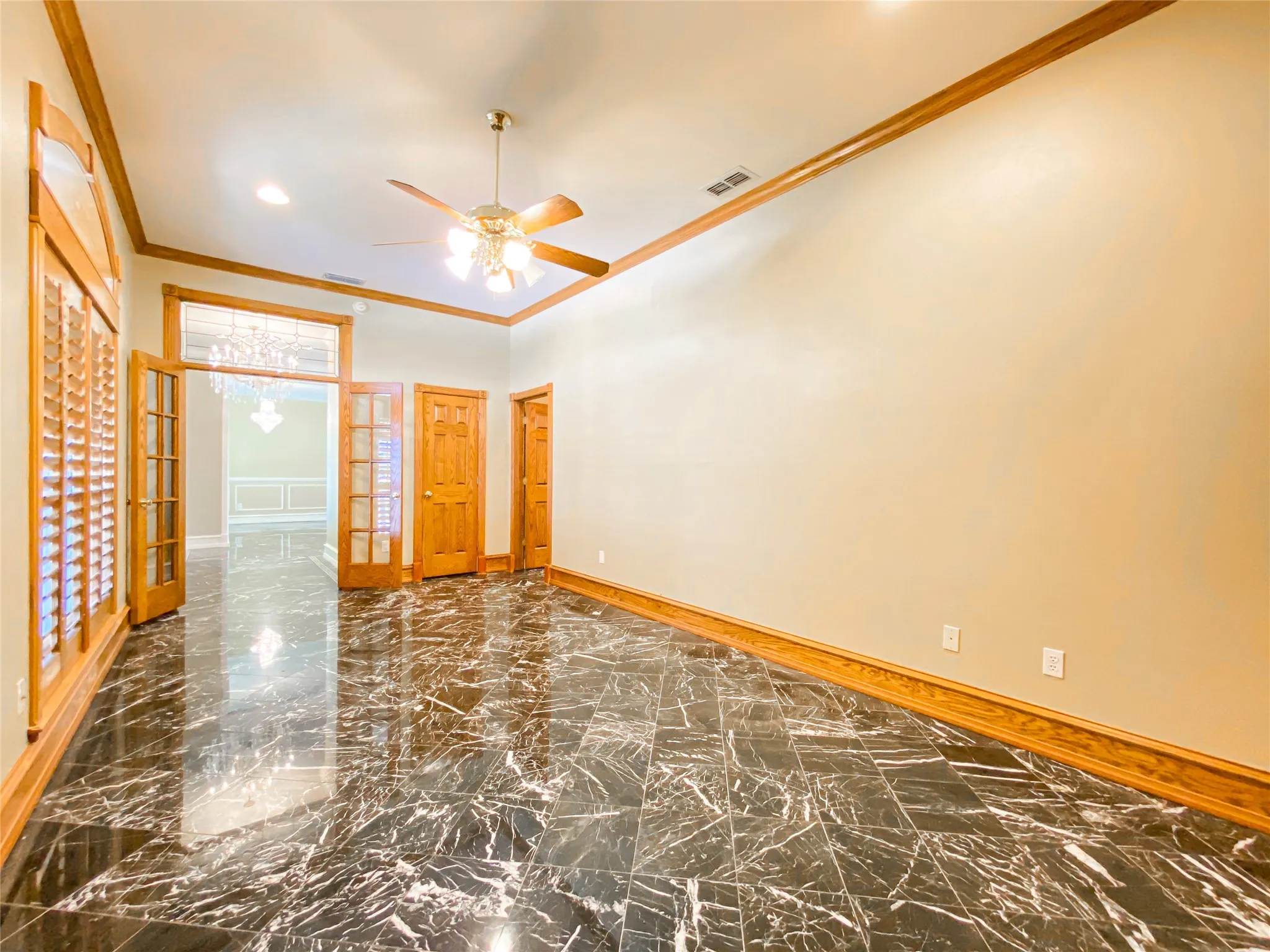 OFFICE OR 5TH BEDROOM with ornamental molding, dark marble finish flooring, french doors, and a ceiling fan