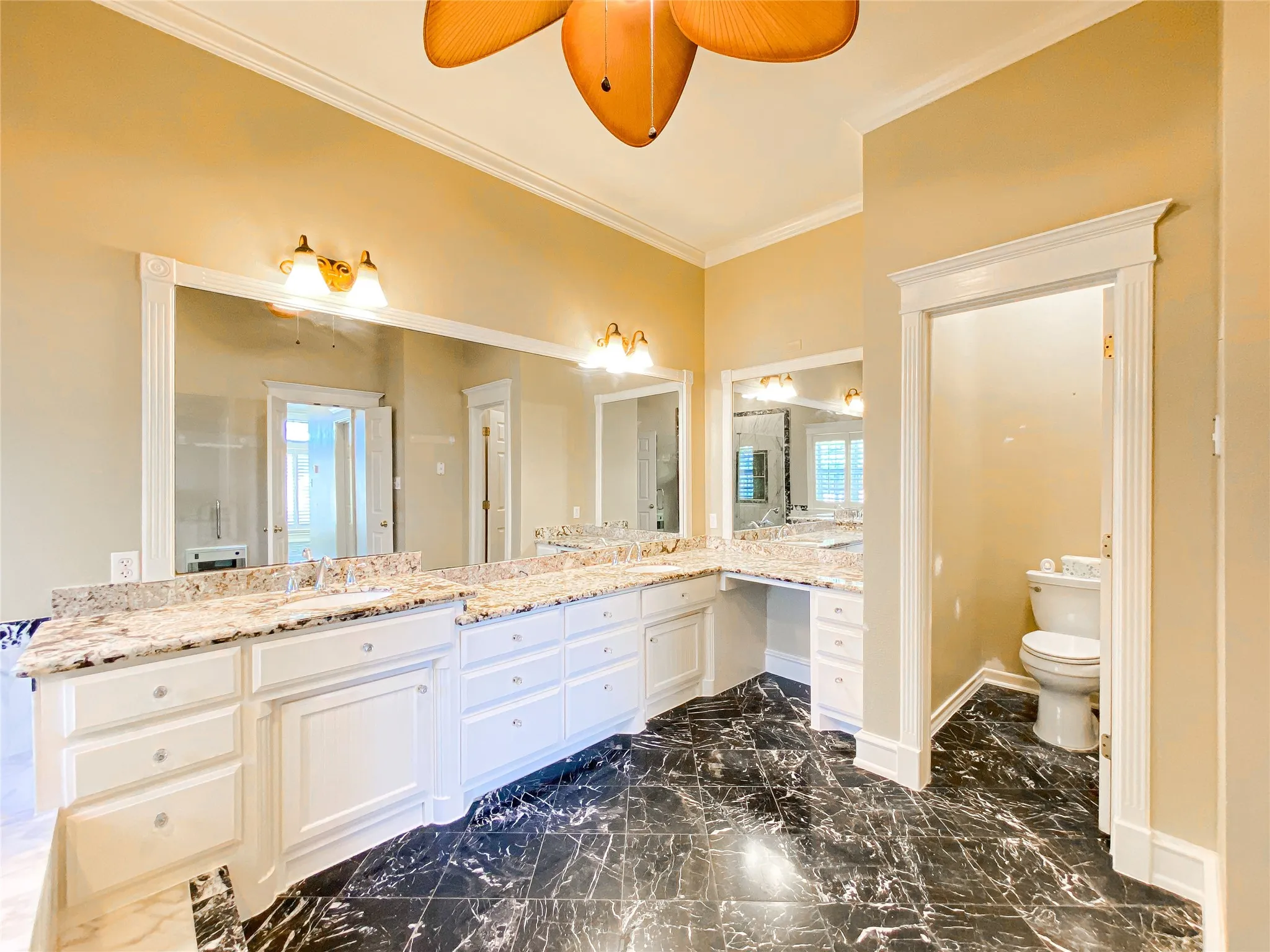 PRIMARY Bathroom featuring vanity, crown molding, and a ceiling fan
