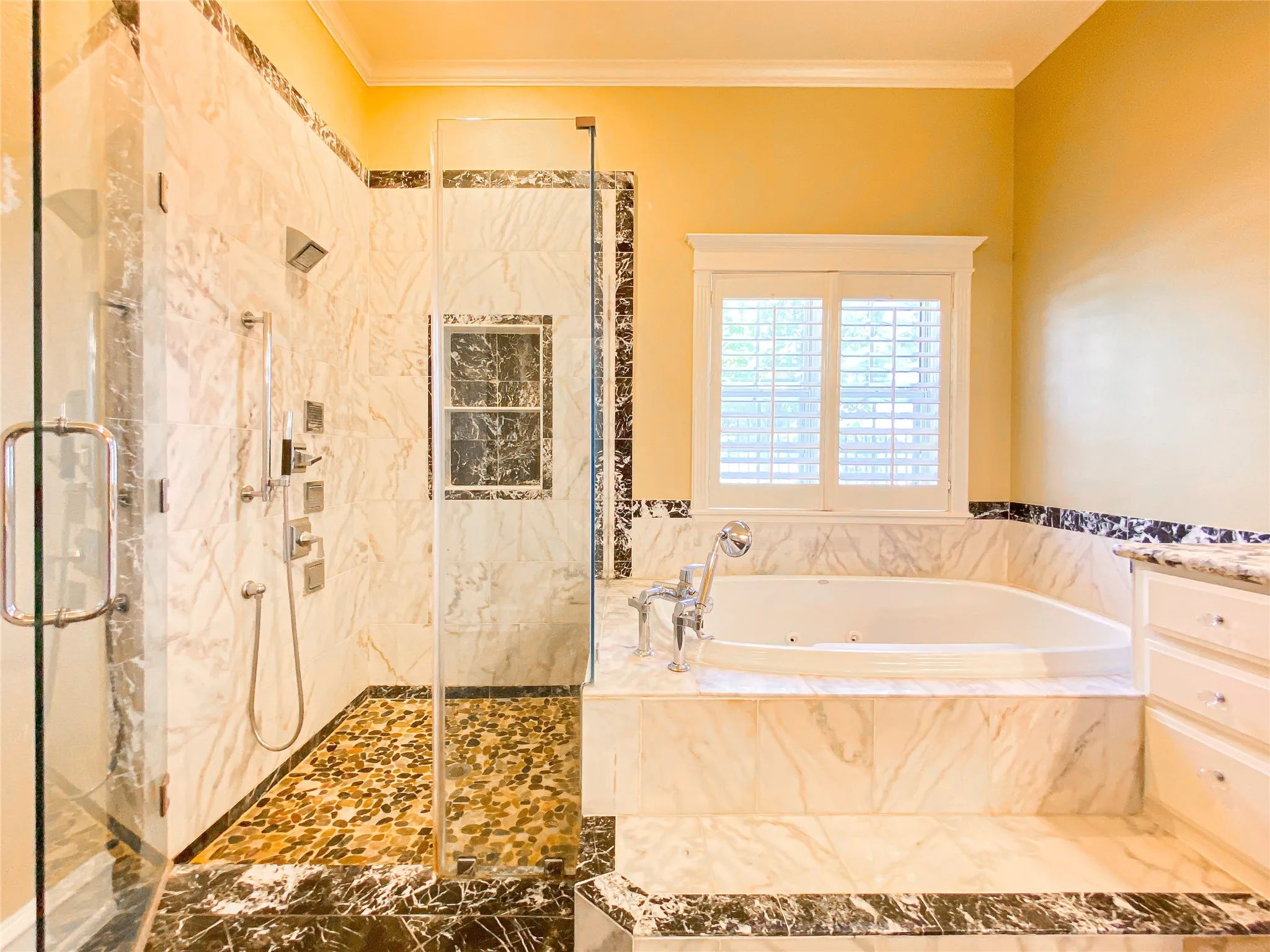 PRIMARY Bathroom featuring a marble finish shower, a tub with jets, ornamental molding, and vanity