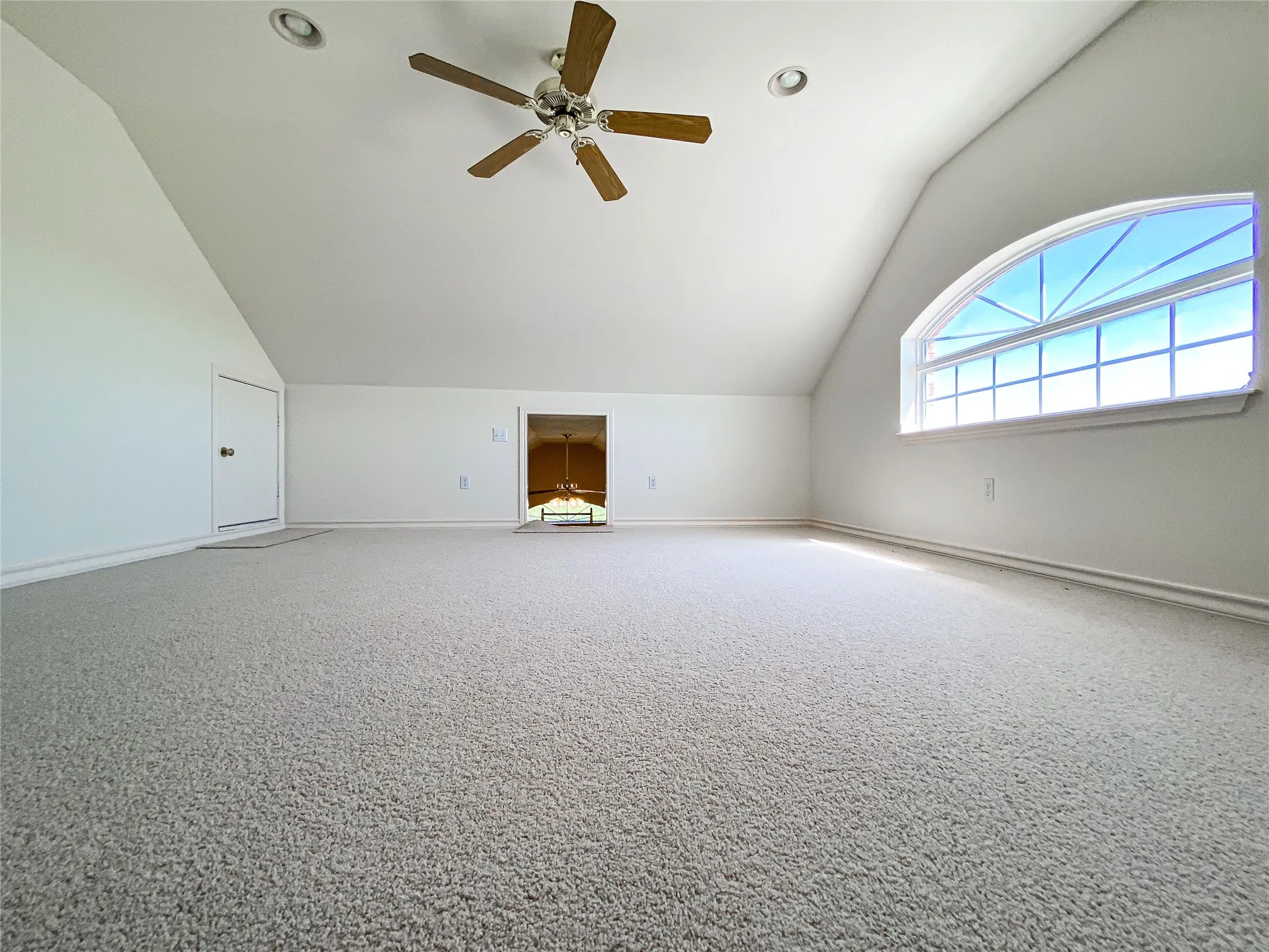Additional living space featuring ceiling fan, lofted ceiling, carpet floors, and recessed lighting