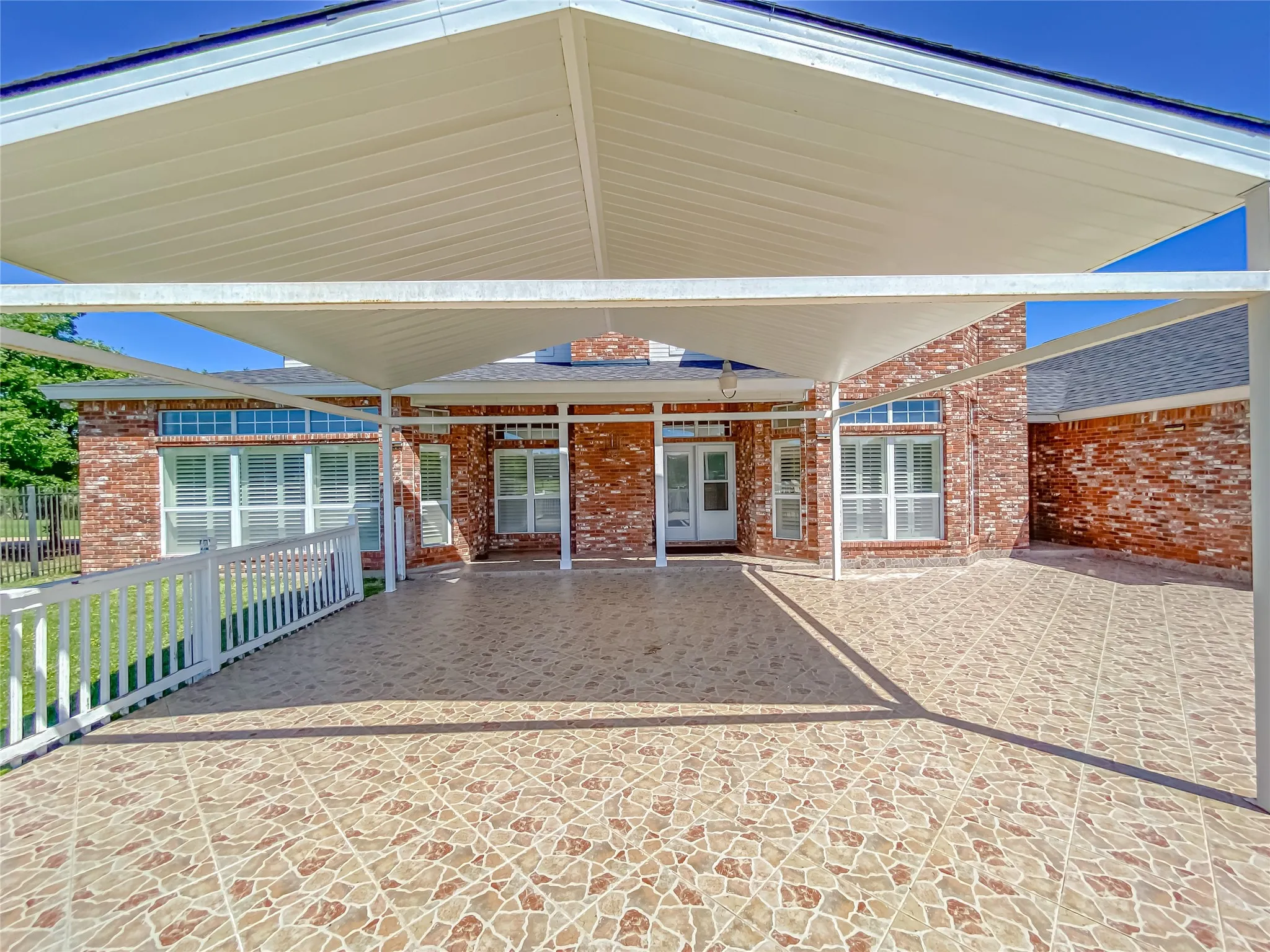 Doorway to property with a patio area and brick siding