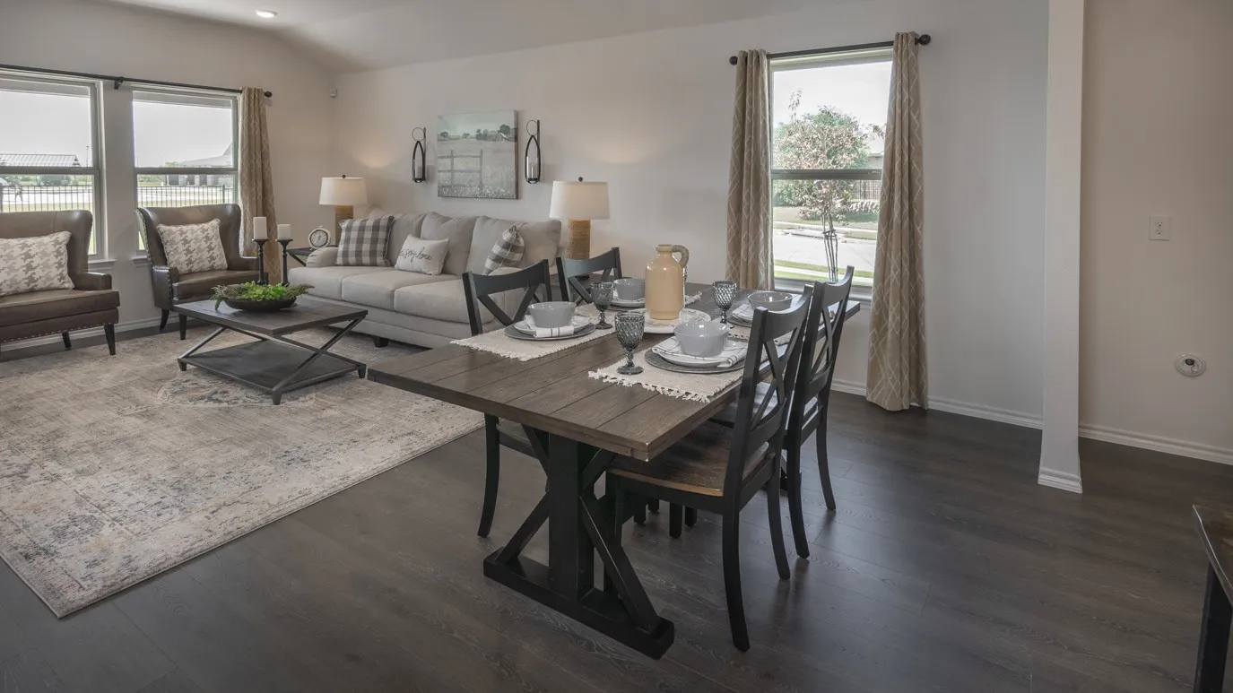 Dining room with dark wood finished floors and vaulted ceiling