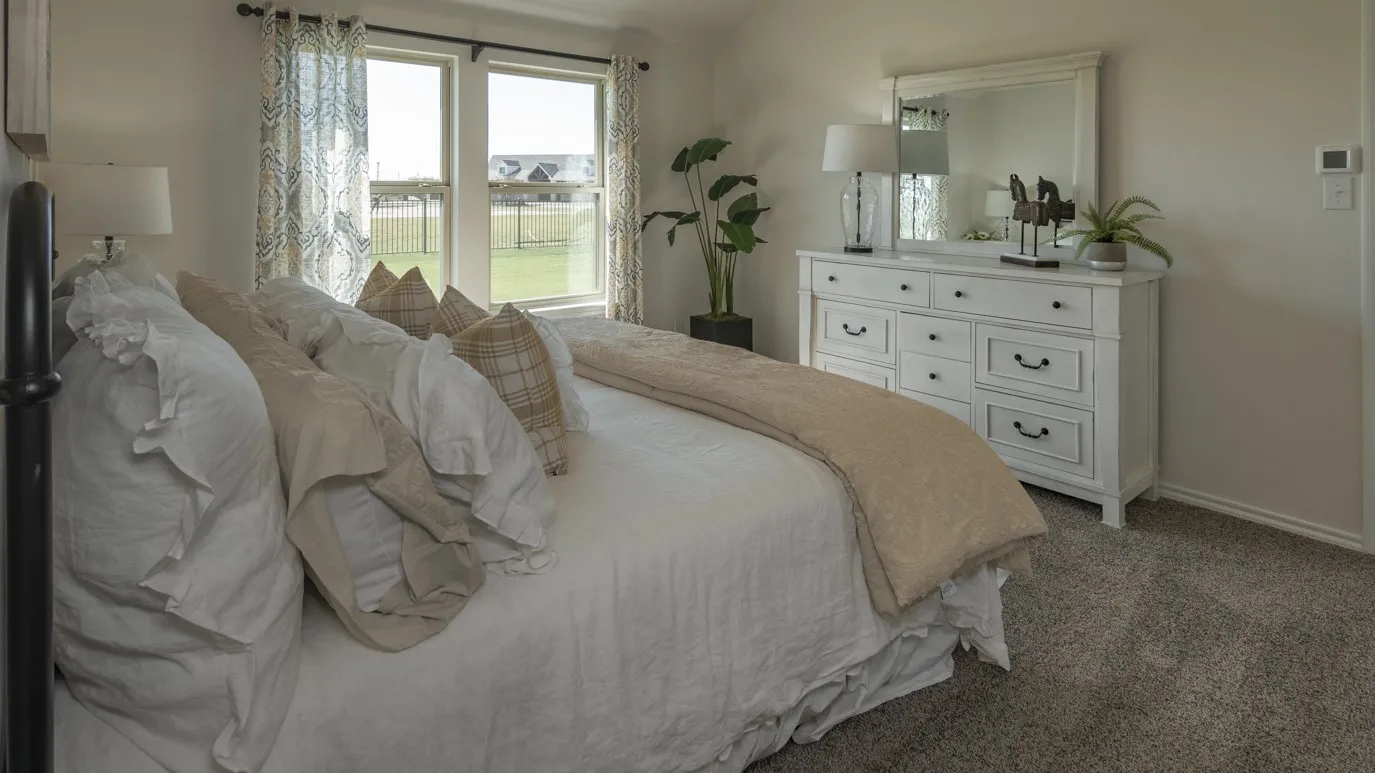 Bedroom featuring carpet floors and baseboards