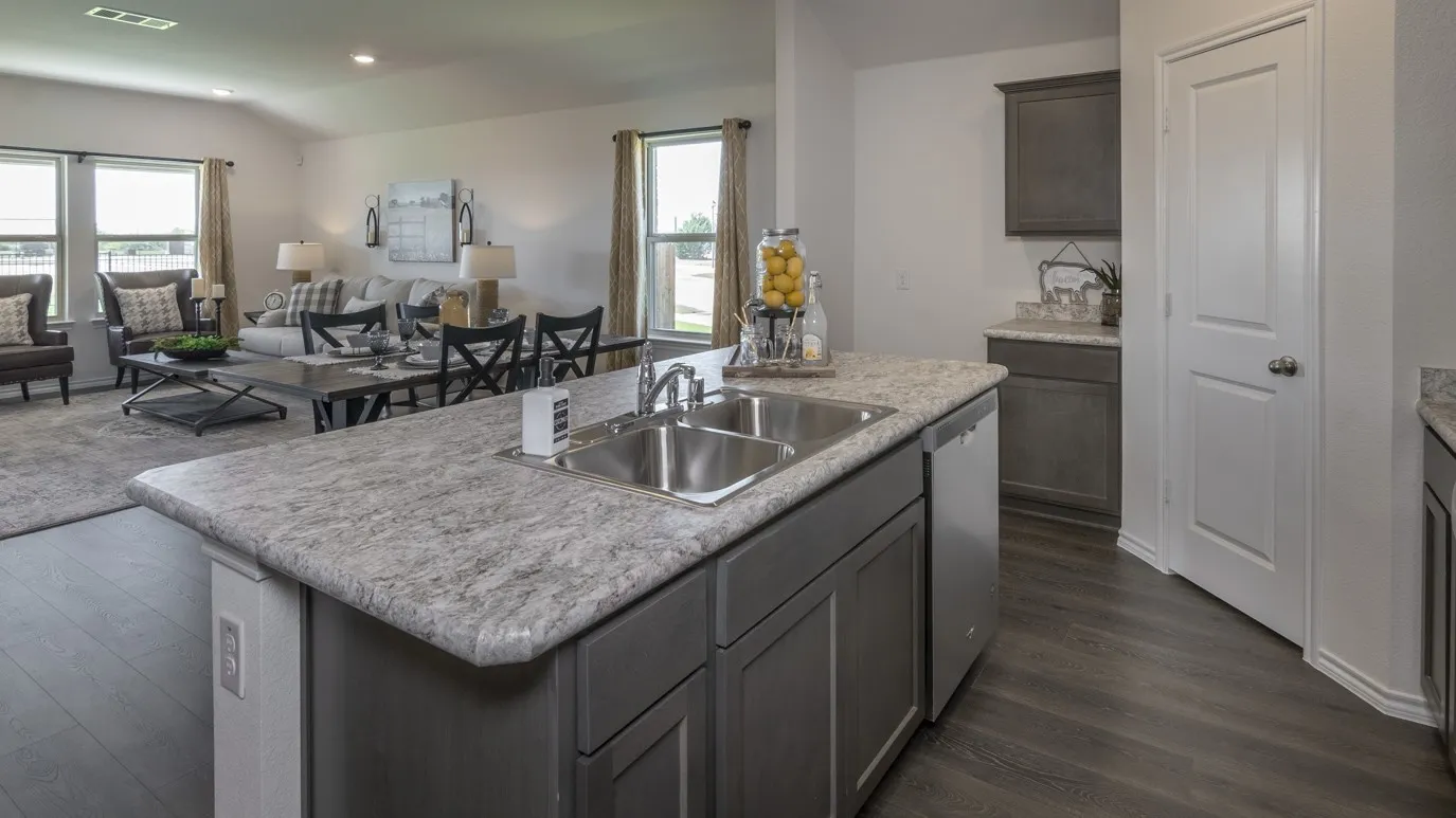 Kitchen with open floor plan, light countertops, plenty of natural light, vaulted ceiling, and recessed lighting