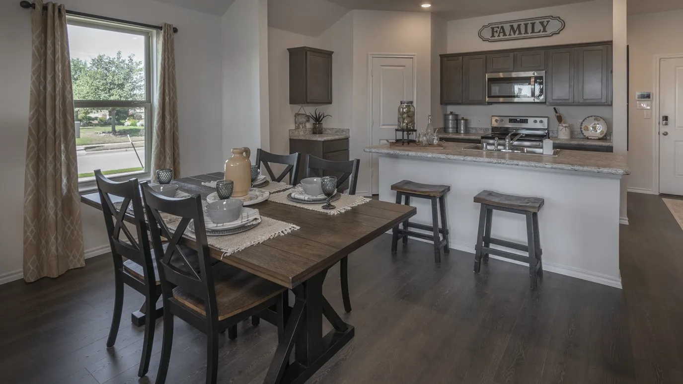 Dining area with dark wood-style floors and baseboards