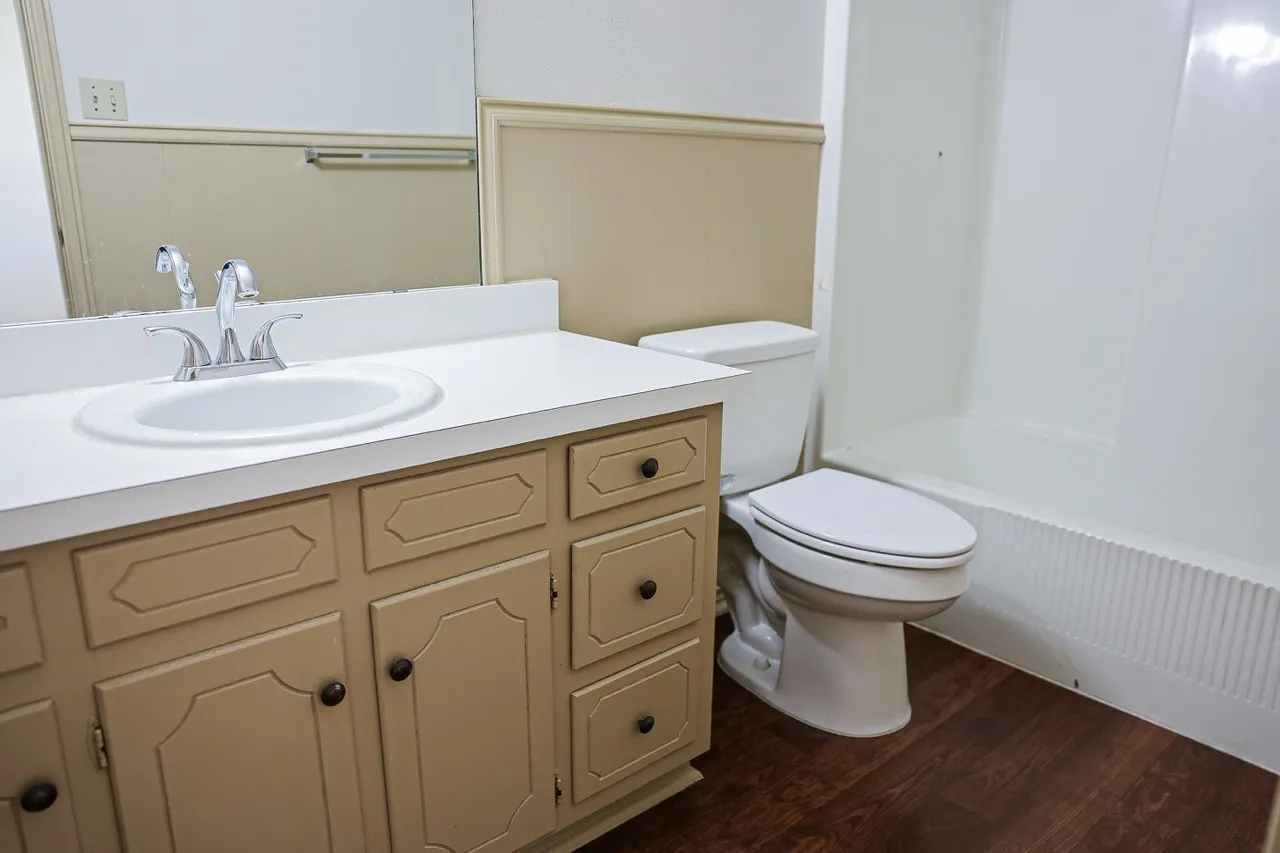 Bathroom featuring a vanity with a white countertop, an integrated sink, and a chrome faucet