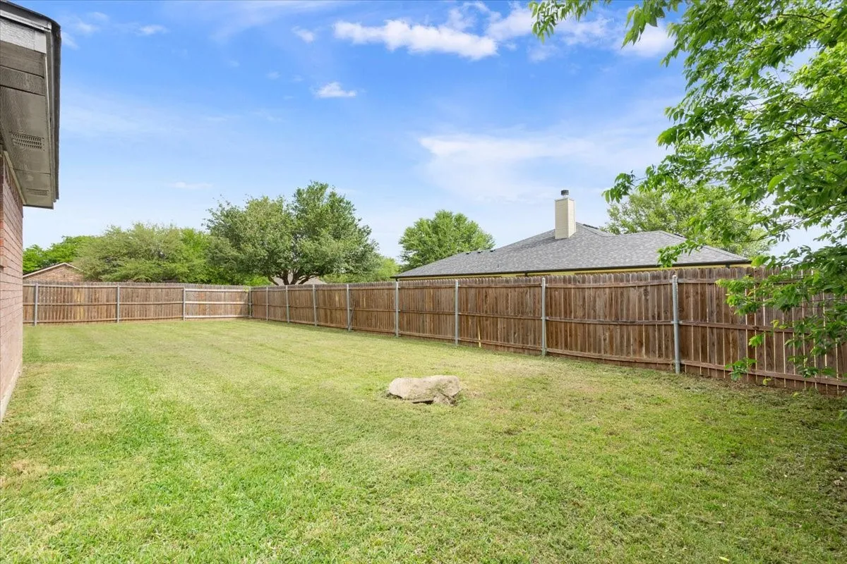 View of fenced backyard