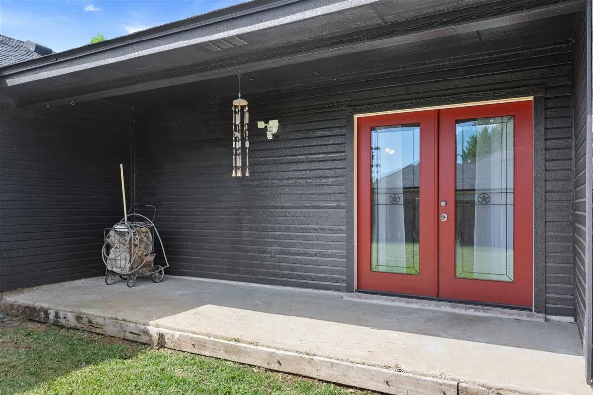 Doorway to property featuring french doors and a porch