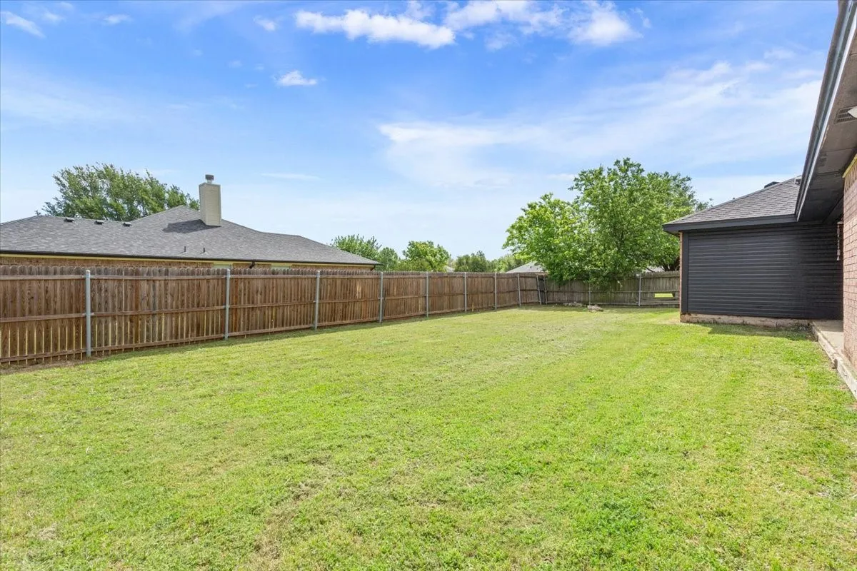 View of fenced backyard