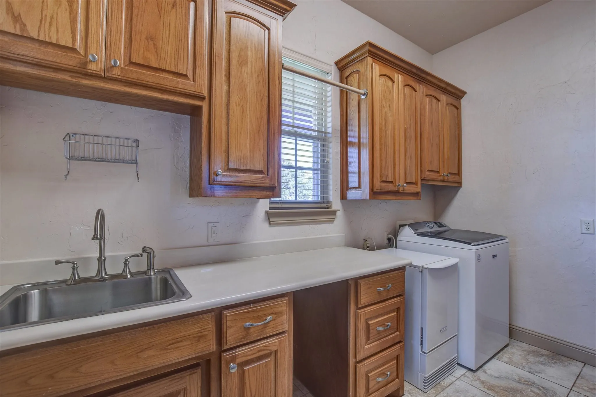 Massive laundry room,  includes washer/dryer, ice maker, sink storage cabinets and room for an extra refrigerator or freezer!