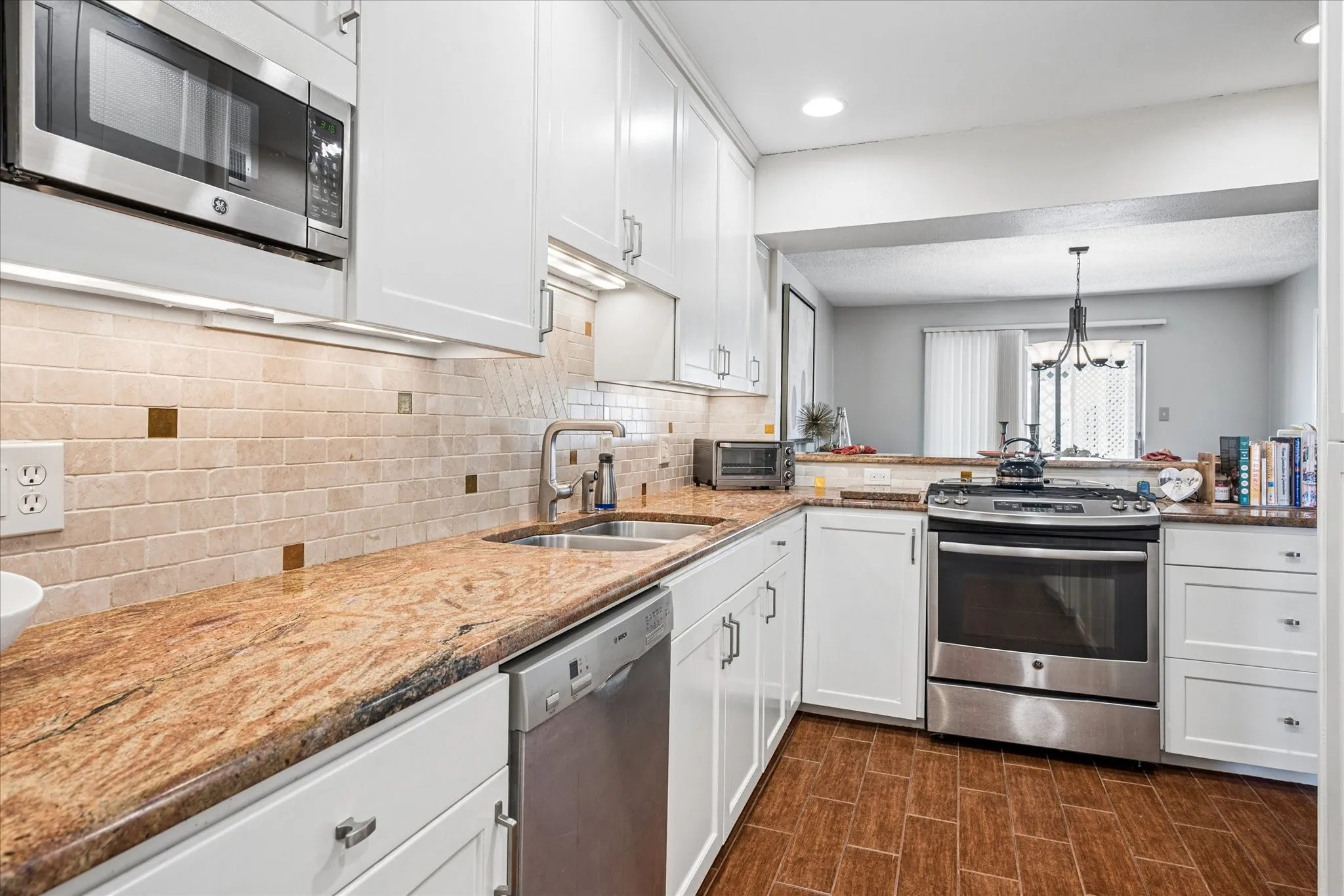 Tastefully updated with a gas range.  Open to the dining room and the cabinets were all replaced and run to the ceiling for added storage.