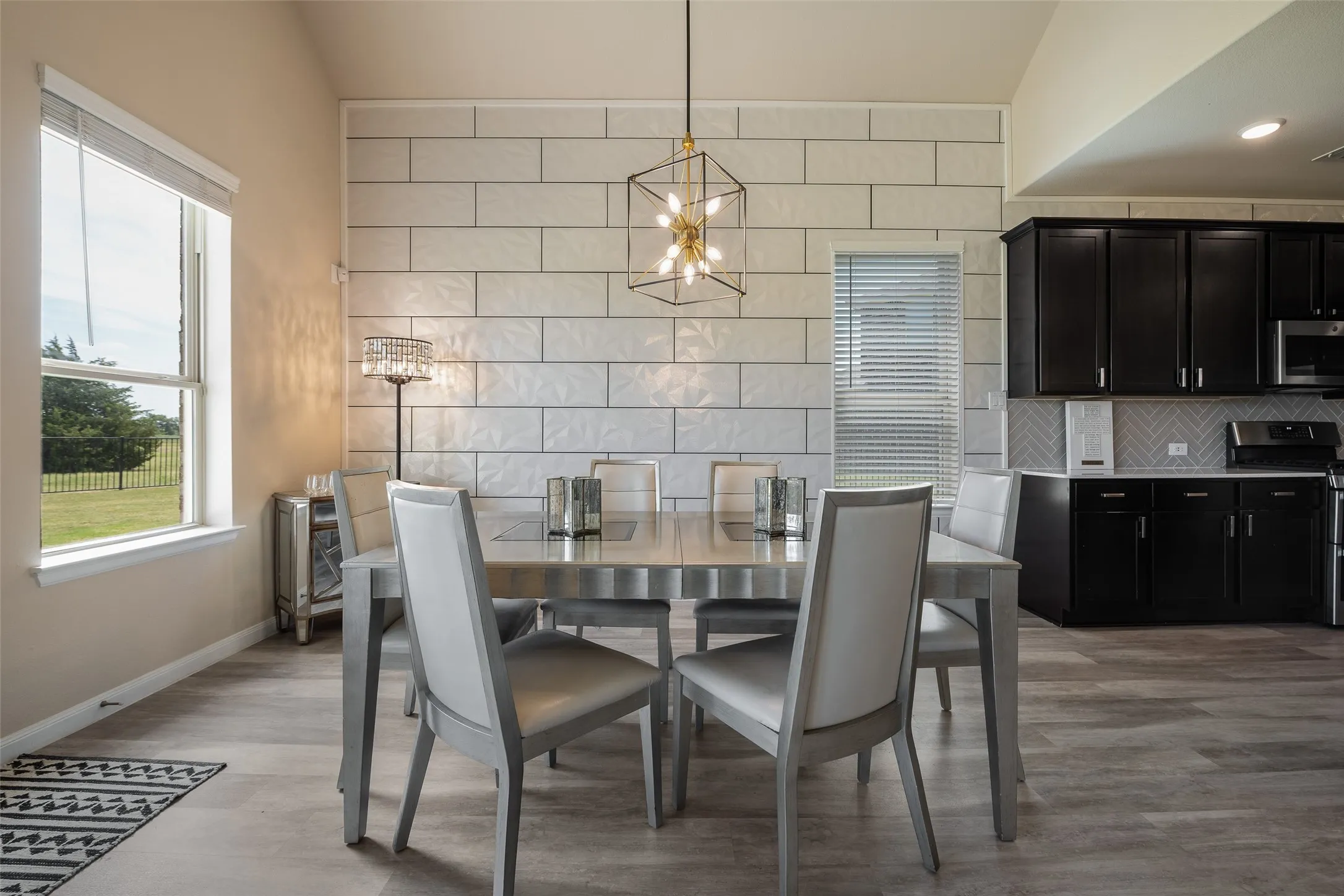 Beautiful and open dining area with stunning designer tile accent wall!