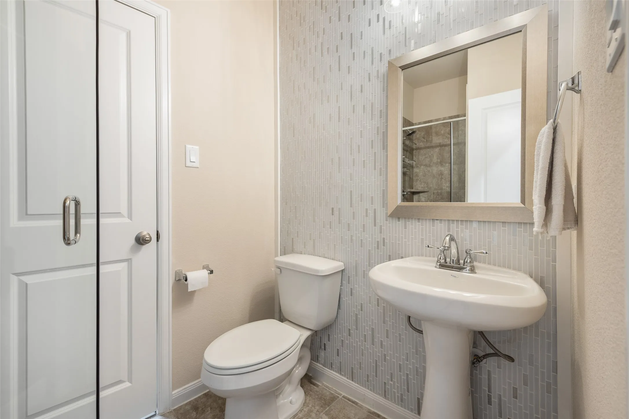 Full bathroom with shower serves as the ensuite bath for the downstairs guest bedroom/office, also serves as the guest bathroom.
